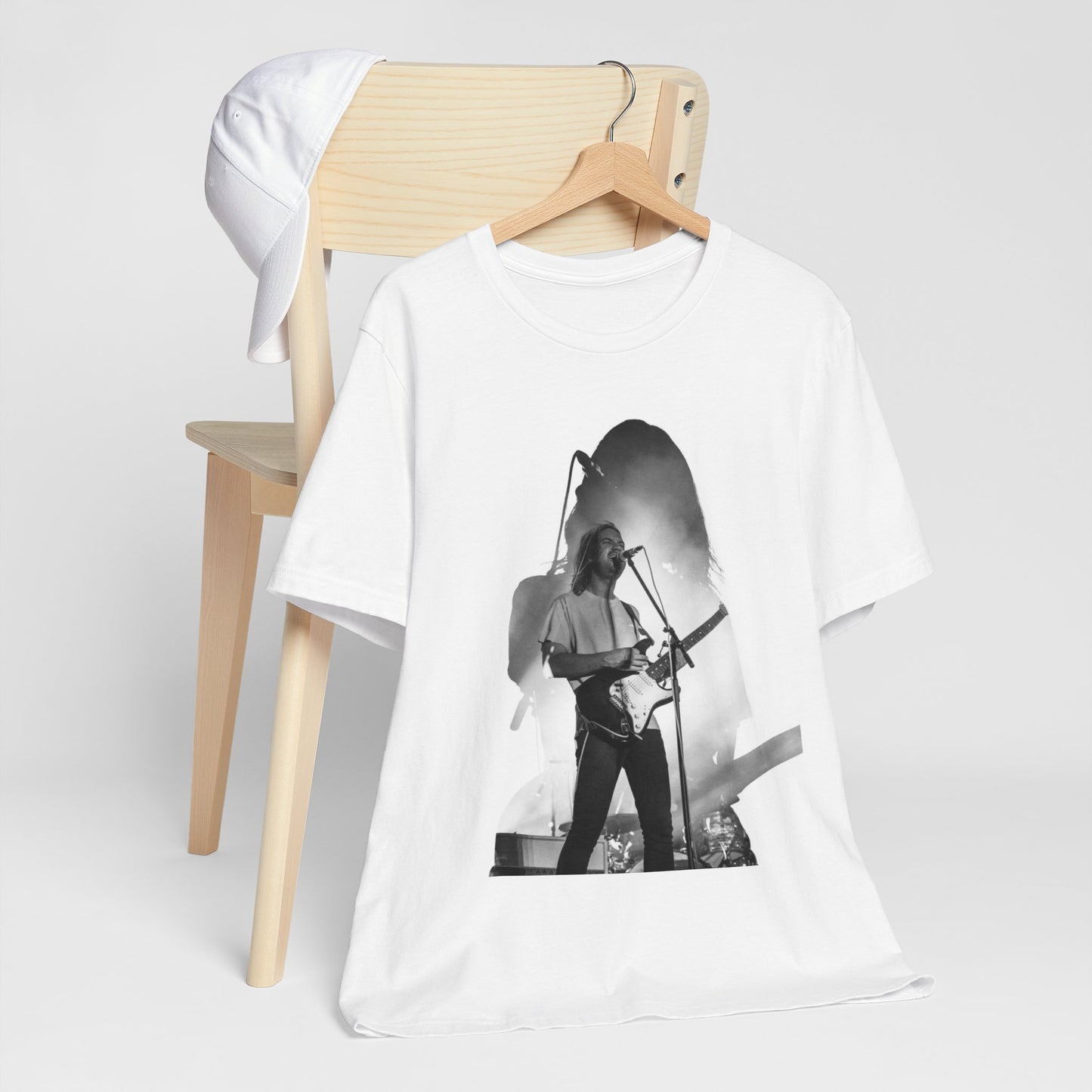 A black graphic t-shirt featuring a black and white, monochrome graphic or photo of Tame Impala.
