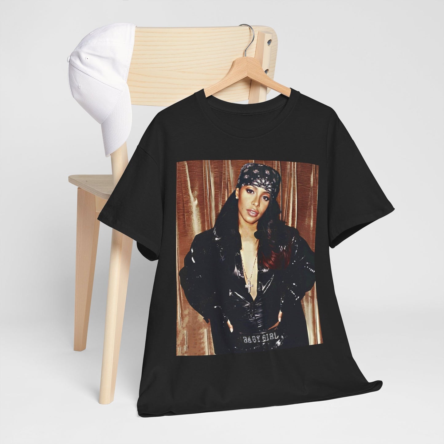 A black graphic t-shirt featuring a tribute graphic for Aaliyah, representing her legacy.