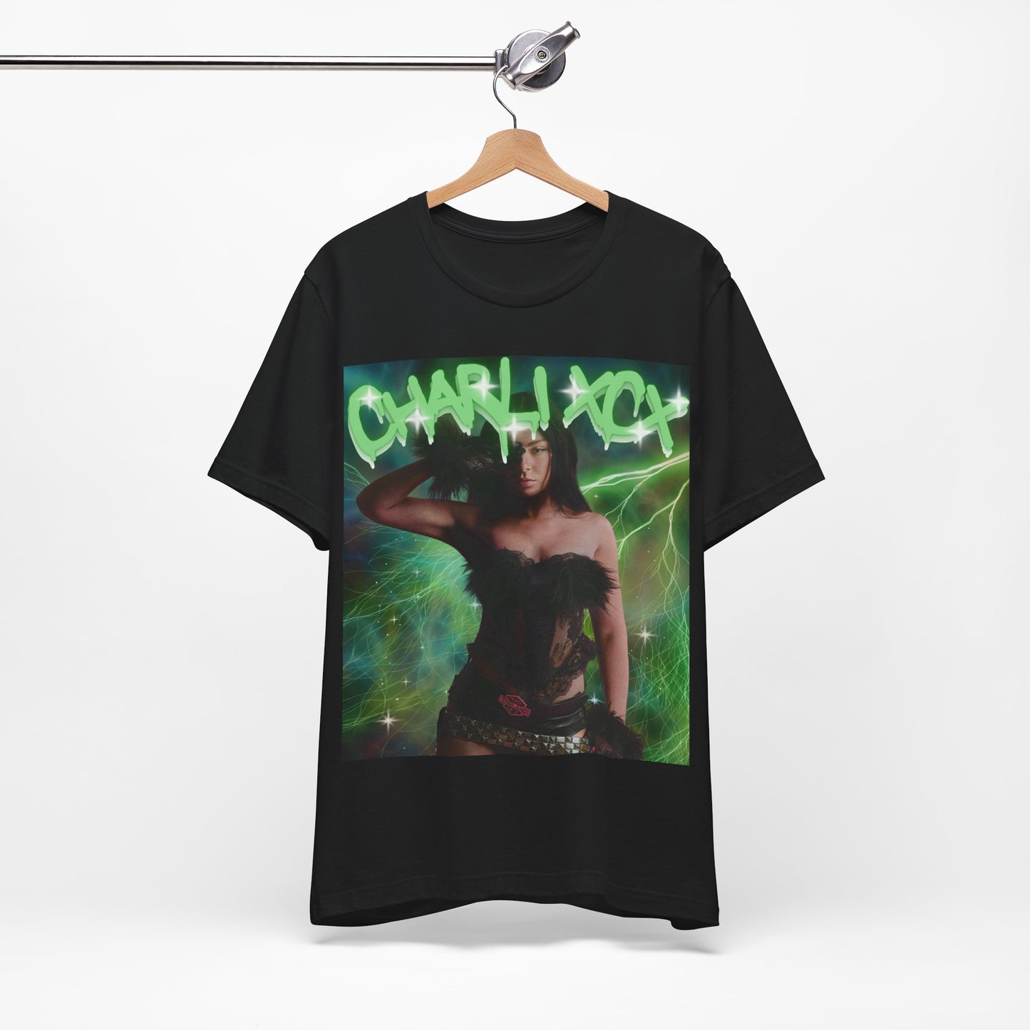 A black graphic t-shirt featuring a retro green neon graphic of Charli XCX's signature.