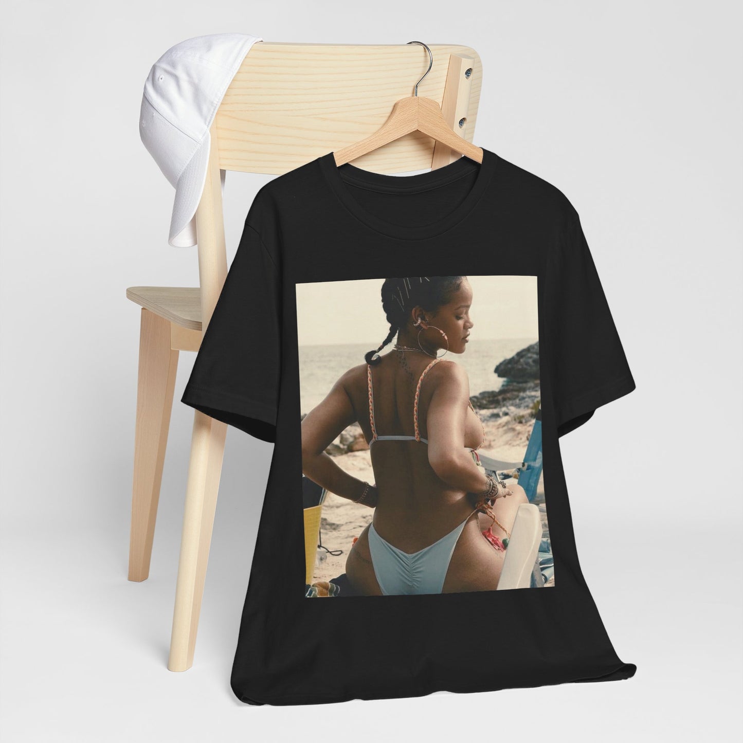 A black graphic t-shirt featuring a graphic of Rihanna as a bikini babe in paradise.