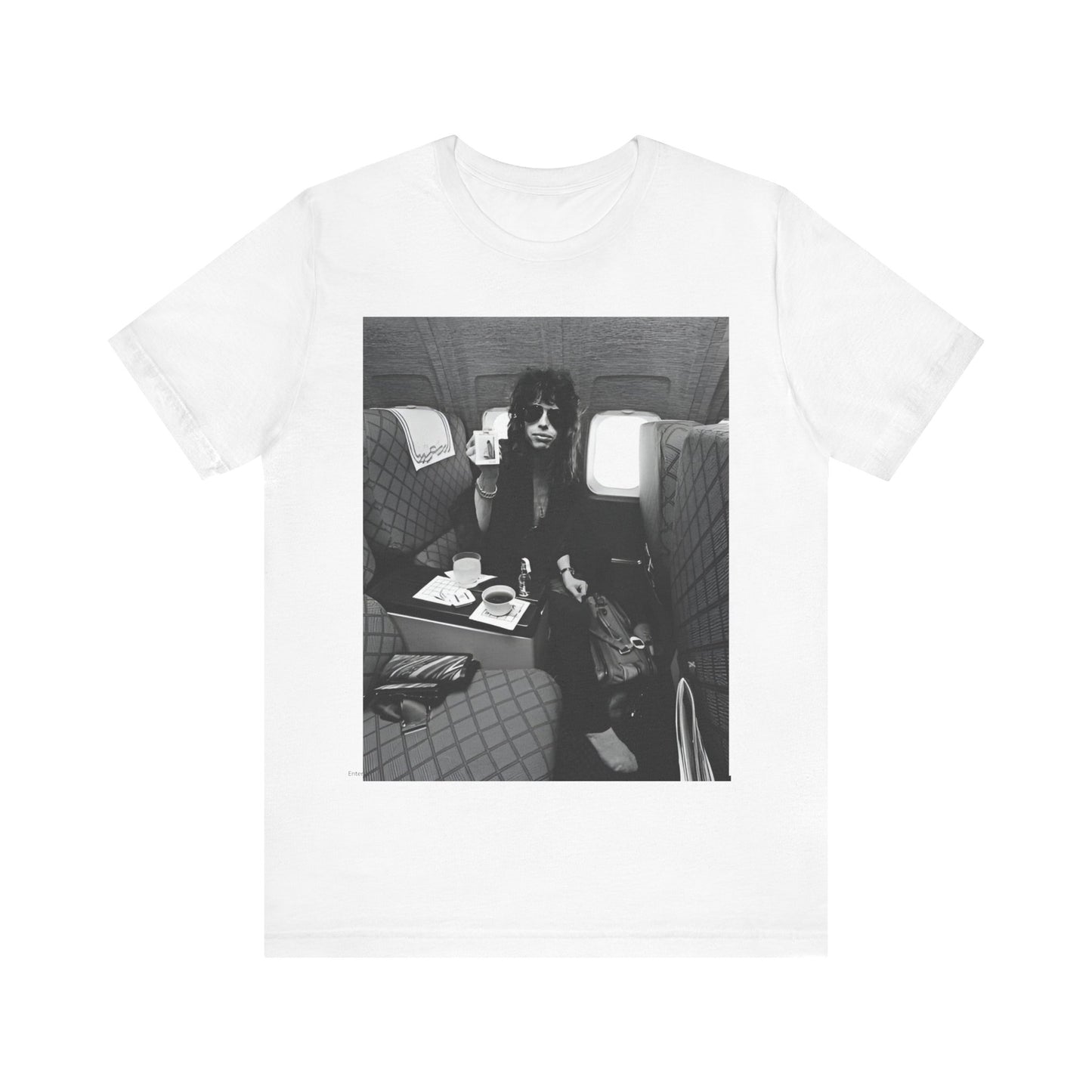 A black graphic t-shirt featuring a vintage 70s-style illustration of an airplane with Aerosmith branding, representing their tour plane from that era.