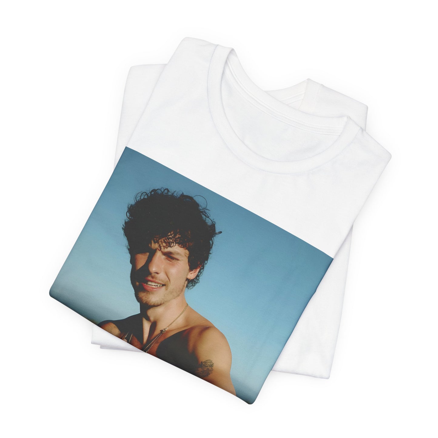 A black graphic t-shirt featuring a graphic of Shawn Mendes with a chill pop star look.