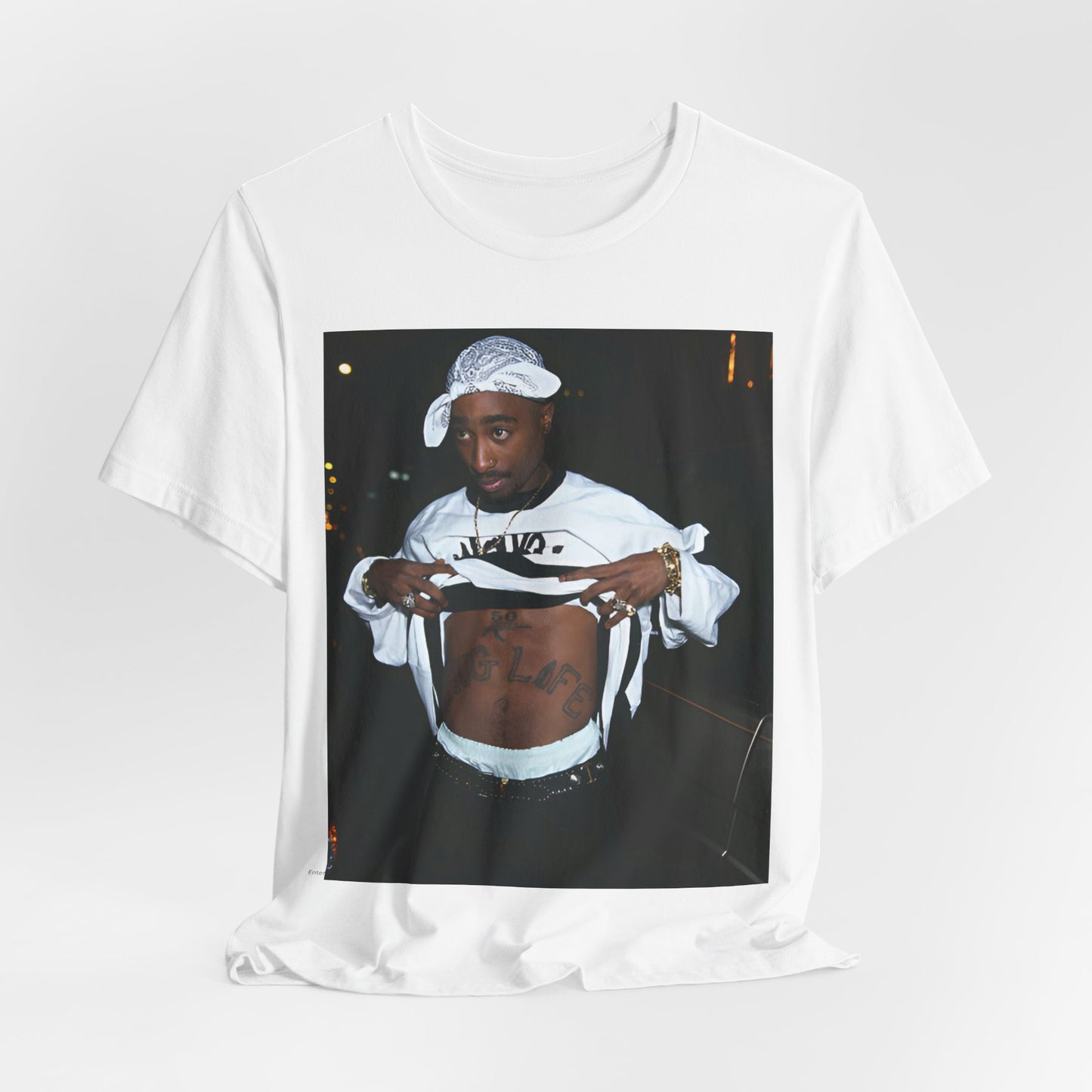 A black graphic t-shirt featuring a graphic of Tupac Shakur (2Pac).