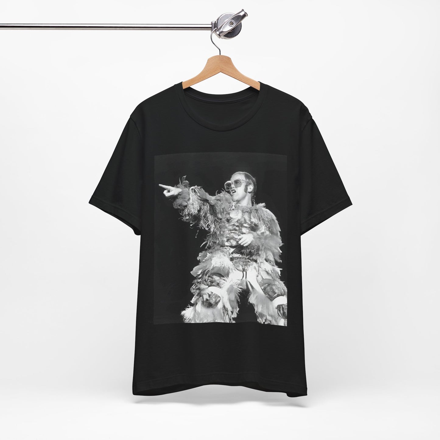 A black graphic t-shirt featuring a retro graphic of Elton John as a rock legend performing live.