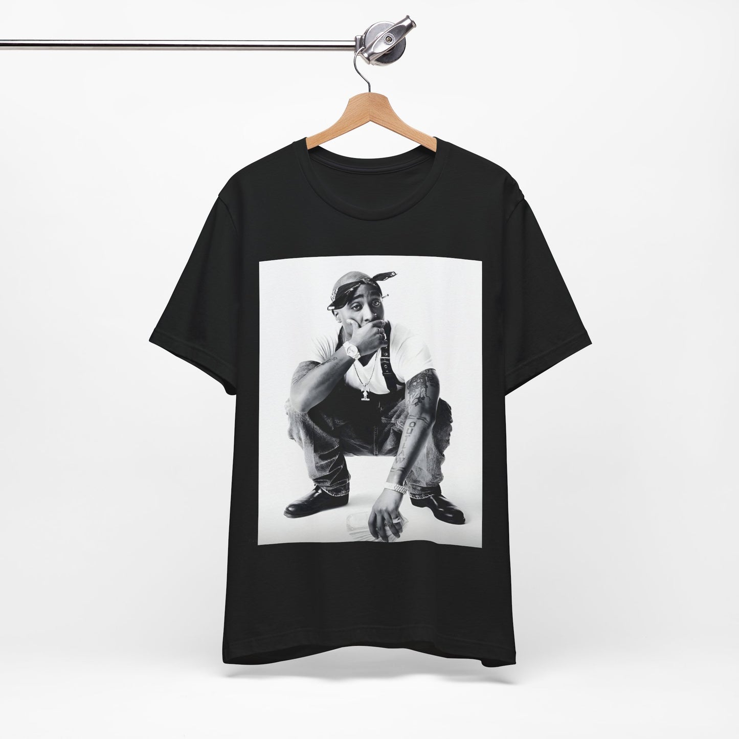 A black graphic t-shirt featuring a graphic of Tupac with a conscious rap vibe.