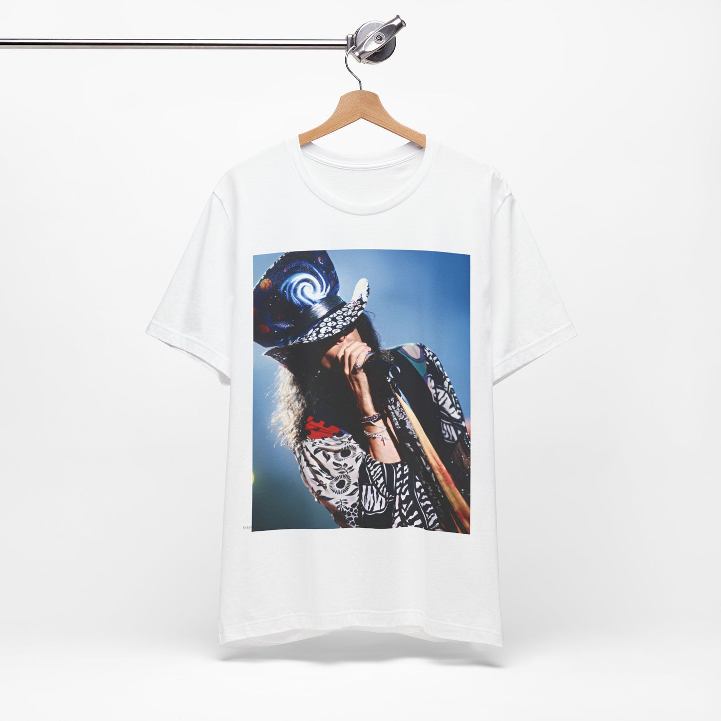 A black graphic t-shirt featuring a vintage 90s photo or illustration of Aerosmith performing live on stage, with band members in dynamic poses.