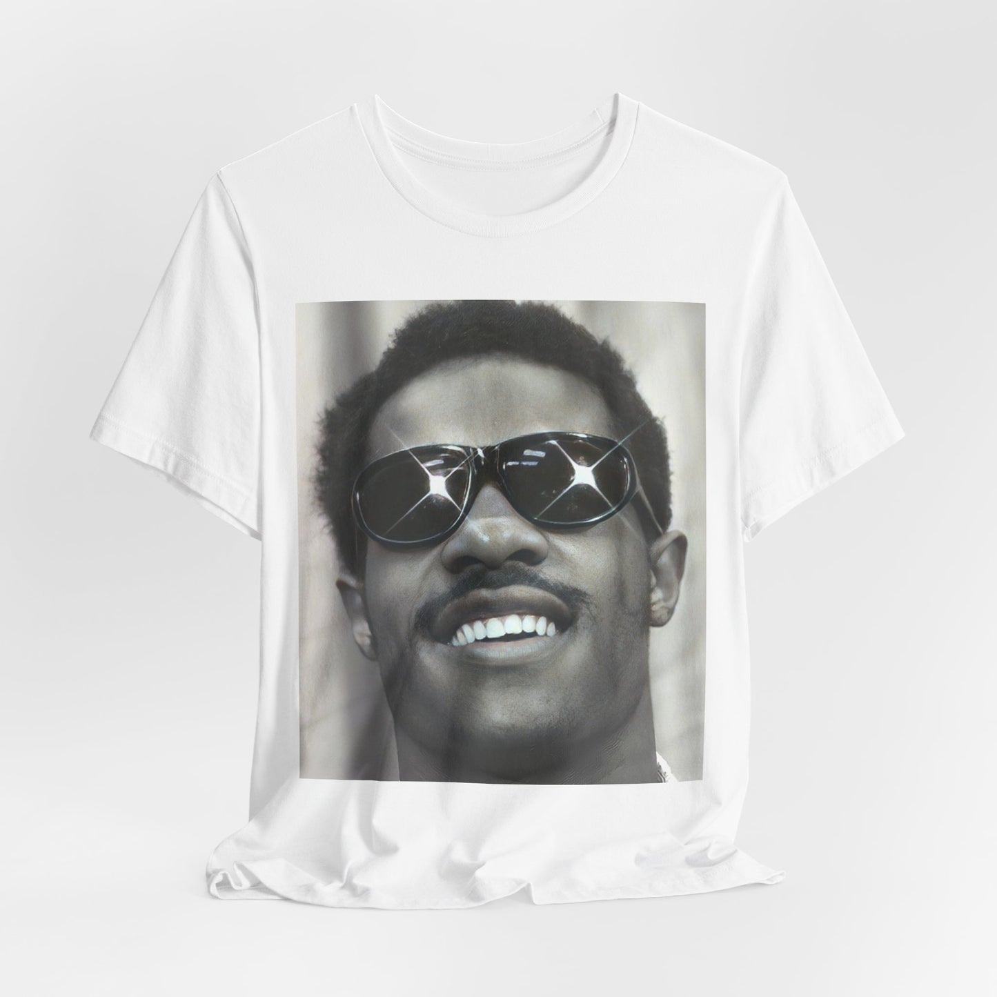 A black graphic t-shirt featuring a 70s funk aesthetic black and white graphic or photo of Stevie Wonder.