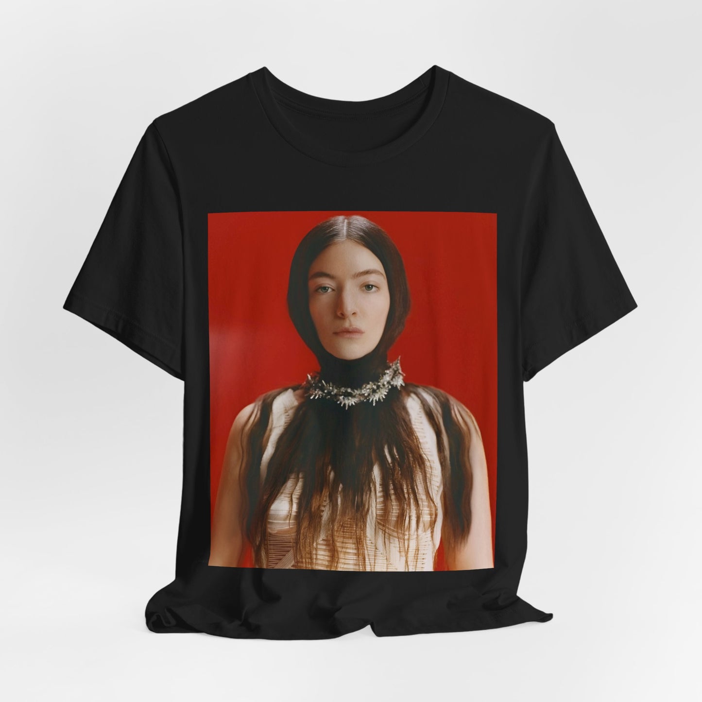 A black graphic t-shirt featuring a vintage indie pop icon graphic of Lorde.