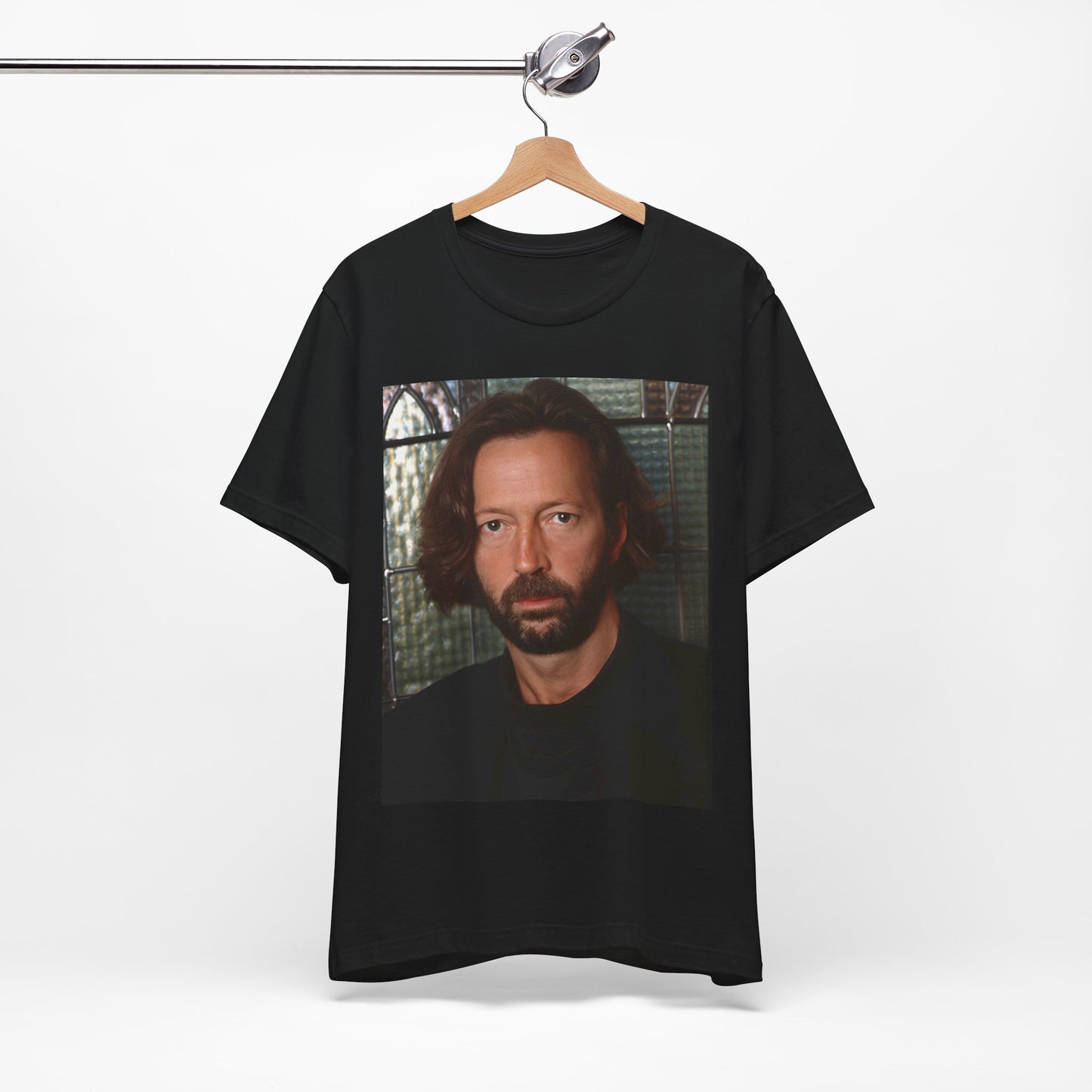 A black graphic t-shirt featuring a portrait graphic of Eric Clapton as a guitar god legend.
