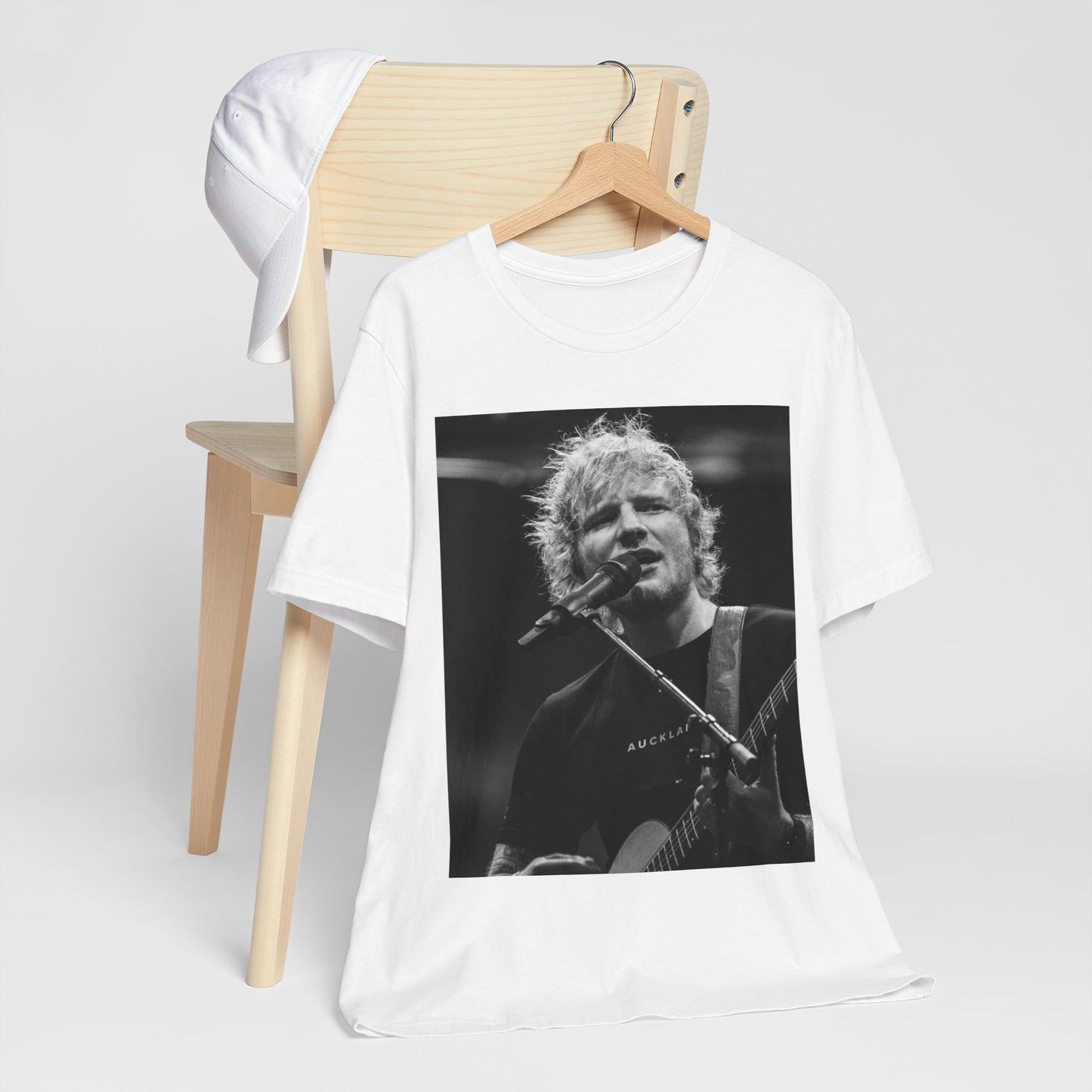 A black graphic t-shirt featuring a black and white photo of Ed Sheeran performing live.