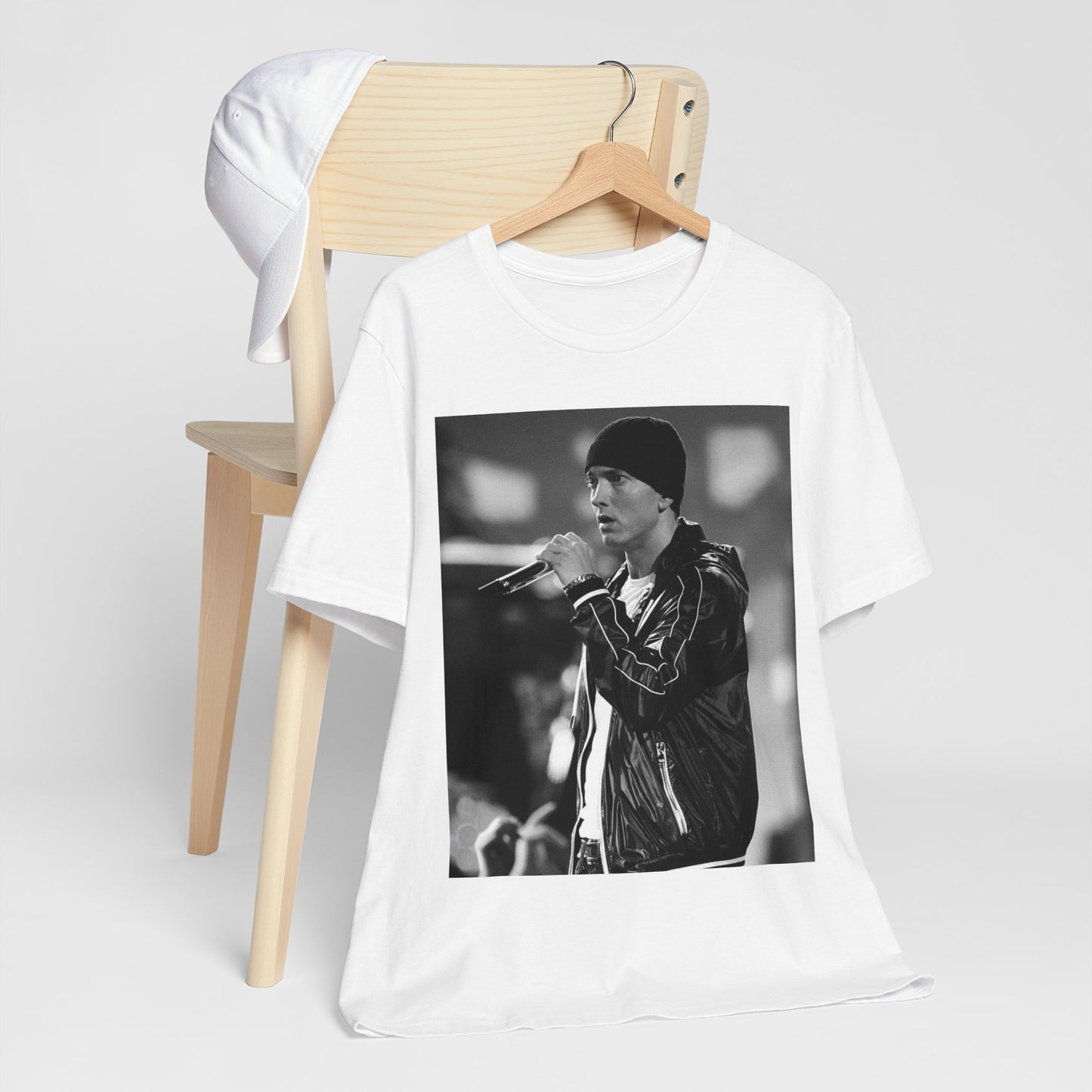 A black graphic t-shirt featuring a classic 90s graphic of Eminem as a 'Rap God'.