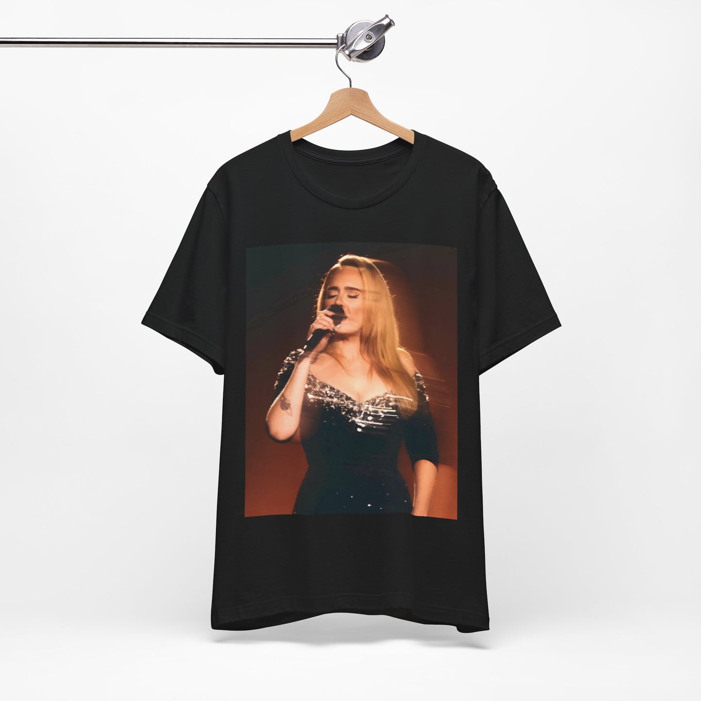 A black graphic t-shirt featuring a stylized image or photo of Adele related to her Las Vegas residency, possibly with elements of stage lighting or show branding.