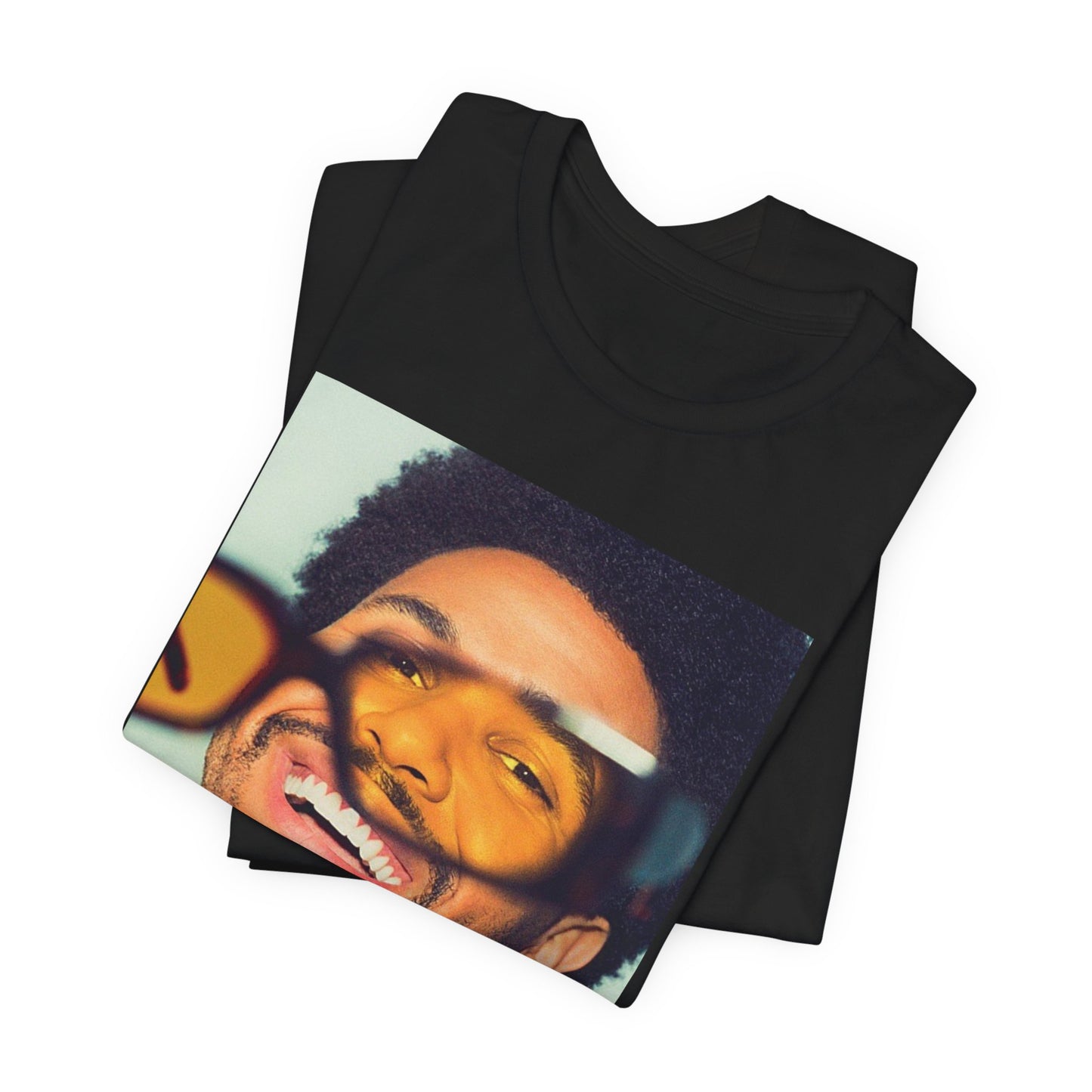 A black graphic t-shirt featuring a bold graphic of The Weeknd as a pop superstar.