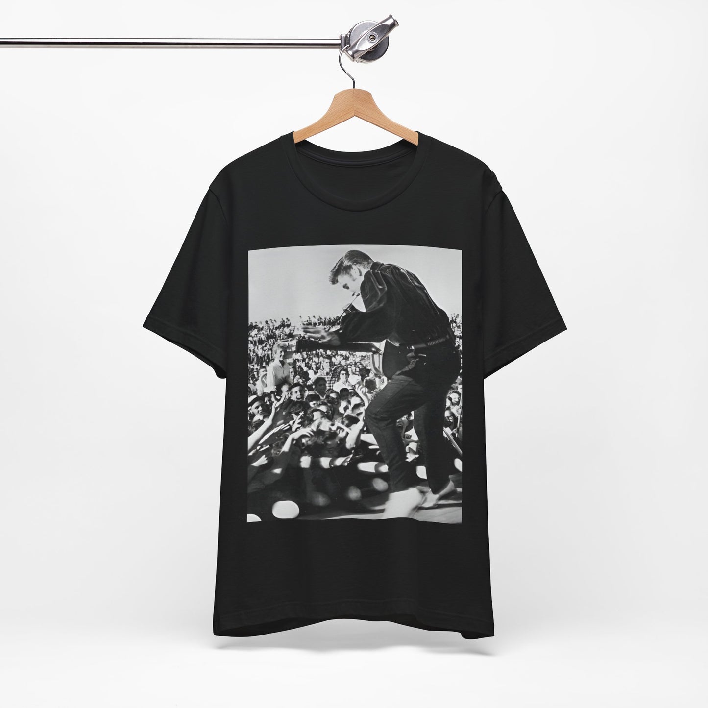 A black graphic t-shirt featuring a retro photo of Elvis Presley performing live in concert in the 1950s.