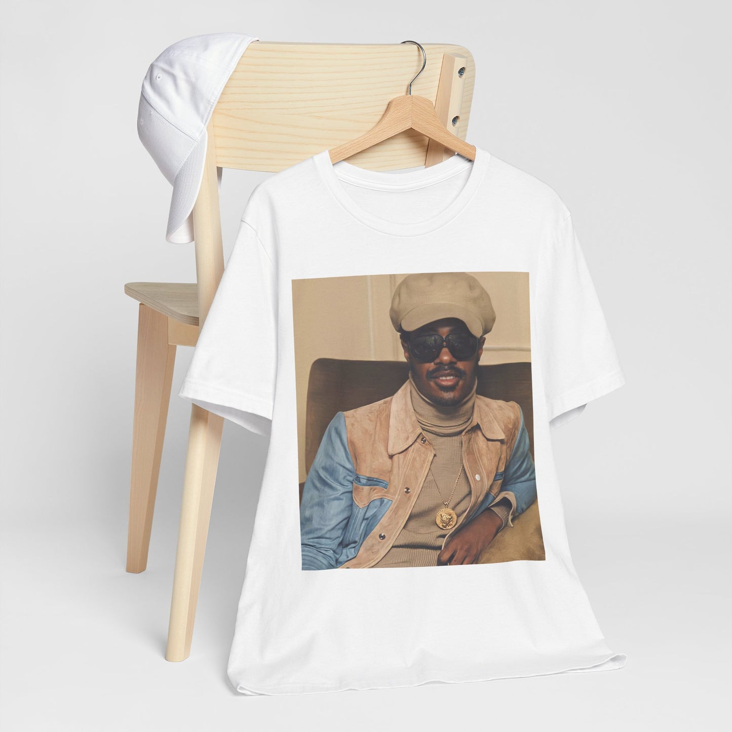 A black graphic t-shirt featuring a retro graphic related to Stevie Wonder's 'Songs in the Key of Life' album era.