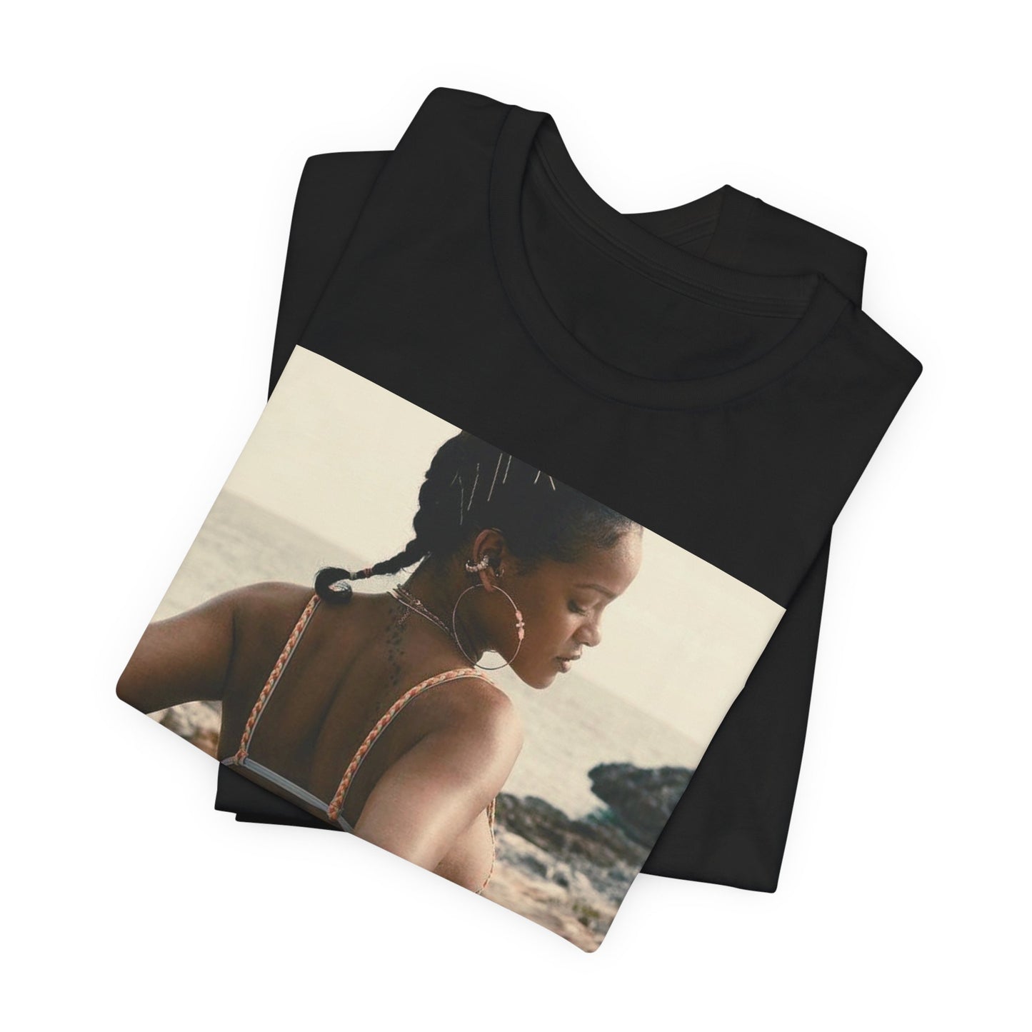 A black graphic t-shirt featuring a graphic of Rihanna as a bikini babe in paradise.