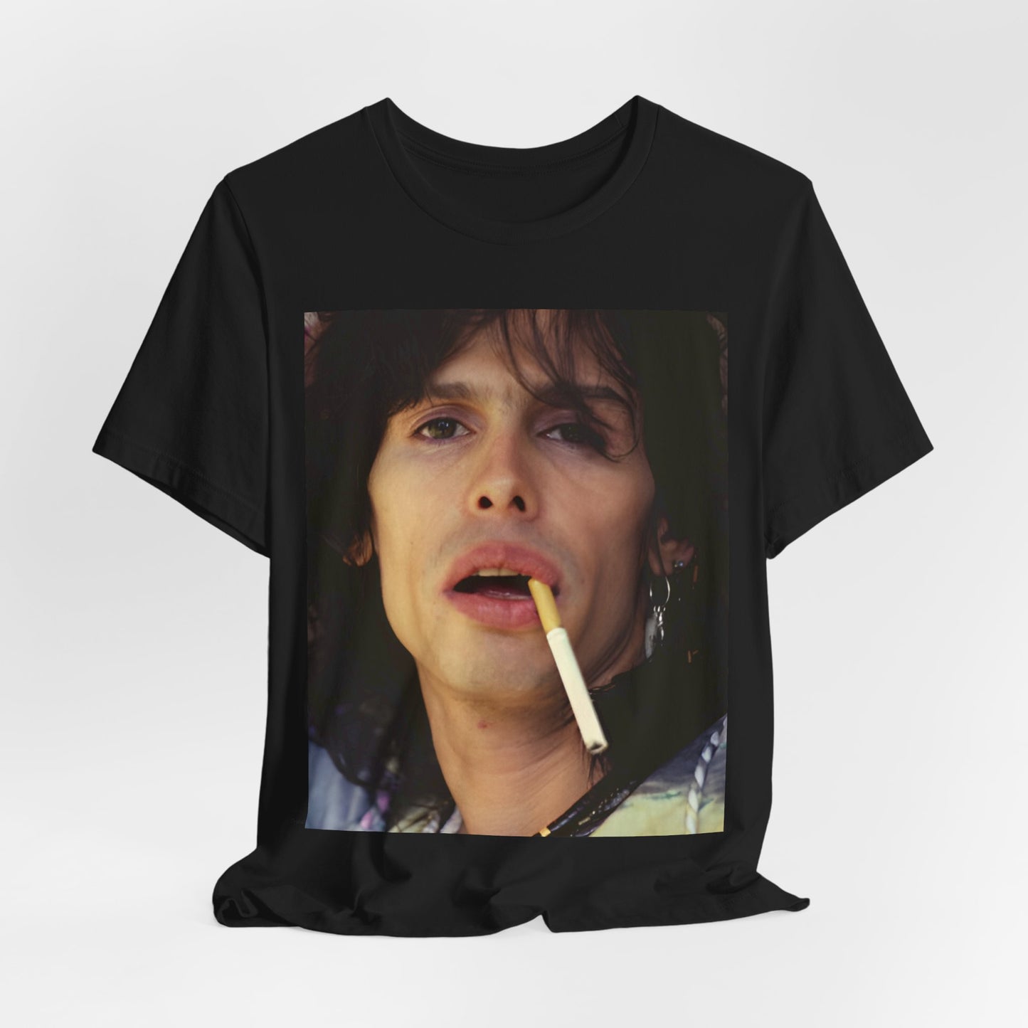 A black graphic t-shirt featuring a vintage 70s graphic design related to Aerosmith's 'Dream On' era, possibly with early band member imagery.