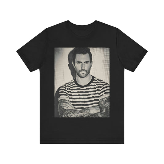 Maroon 5 t-shirt featuring a soft, moody portrait with stage light tones and warm contrast, printed on black cotton.