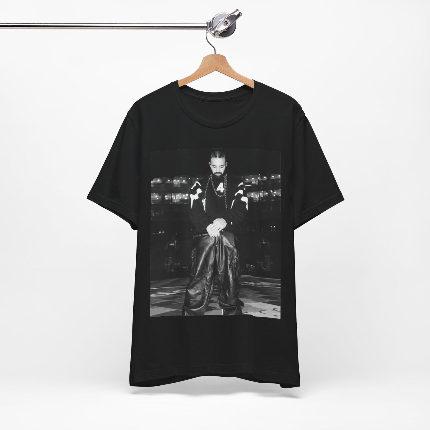 A black graphic t-shirt featuring a black and white aesthetic graphic of Drake, possibly with tour elements.