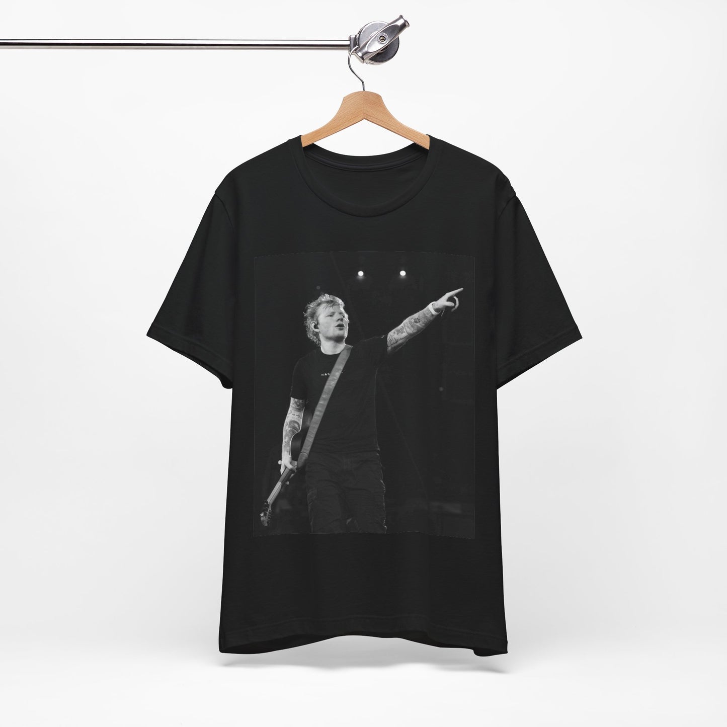A black graphic t-shirt featuring a black and white graphic or photo of Ed Sheeran performing live on stage.