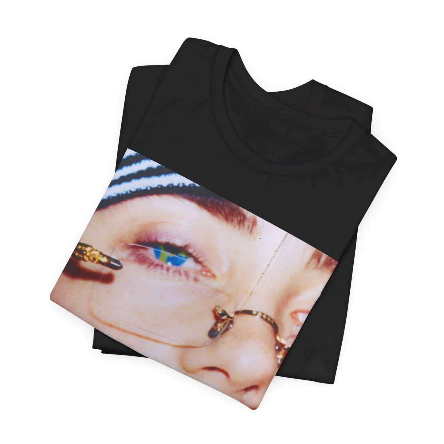 A direct, unfiltered, close-up portrait of Billie Eilish with dark hair looking straight at the camera, printed on a t-shirt.