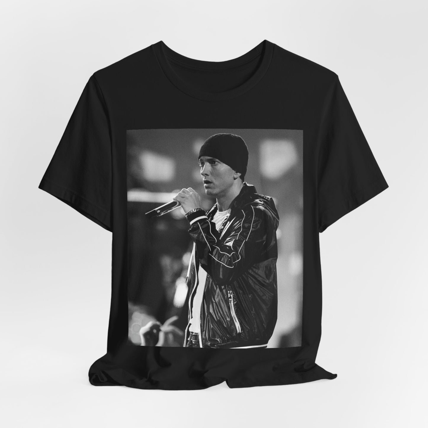 A black graphic t-shirt featuring a classic 90s graphic of Eminem as a 'Rap God'.