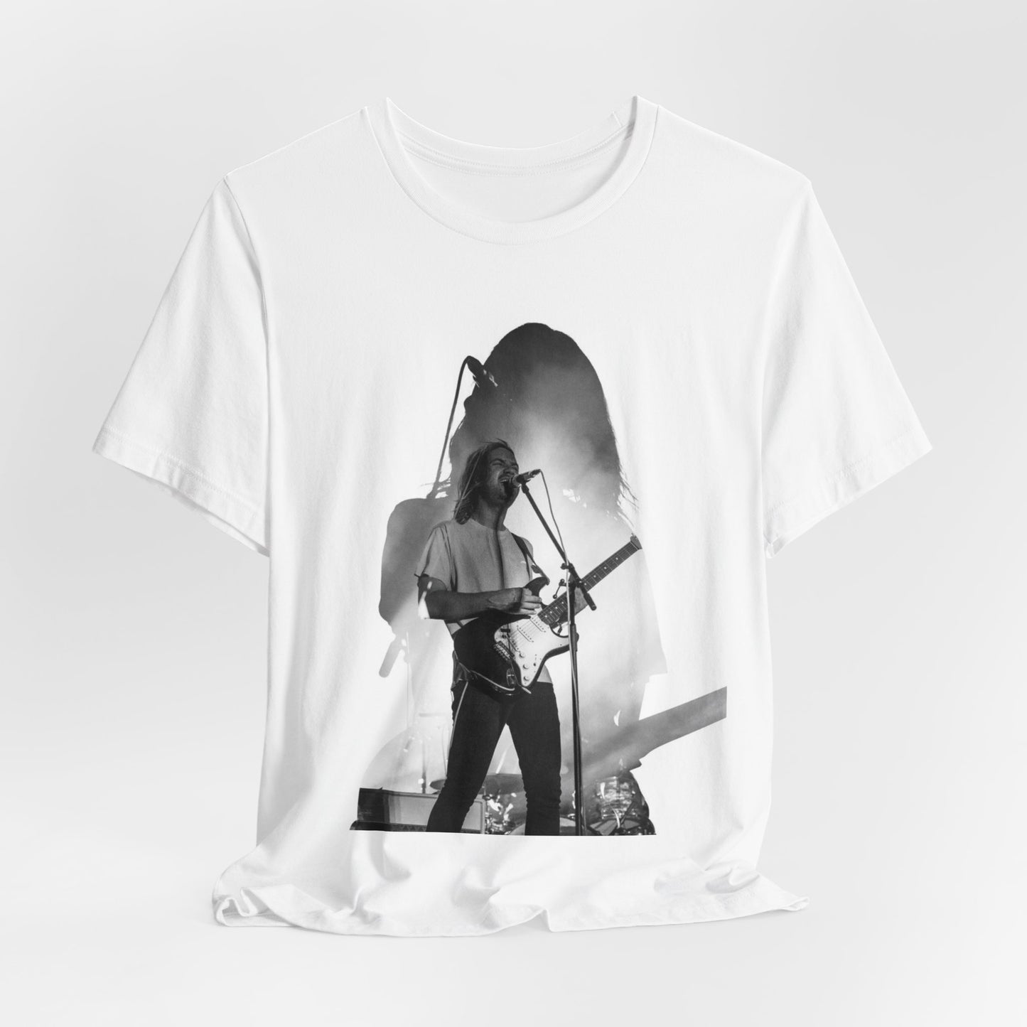 A black graphic t-shirt featuring a black and white, monochrome graphic or photo of Tame Impala.