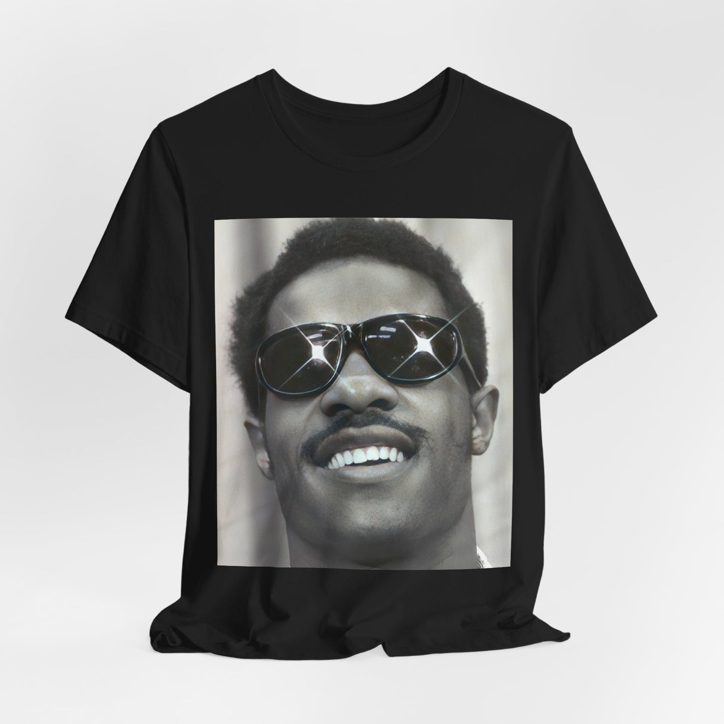 A black graphic t-shirt featuring a 70s funk aesthetic black and white graphic or photo of Stevie Wonder.