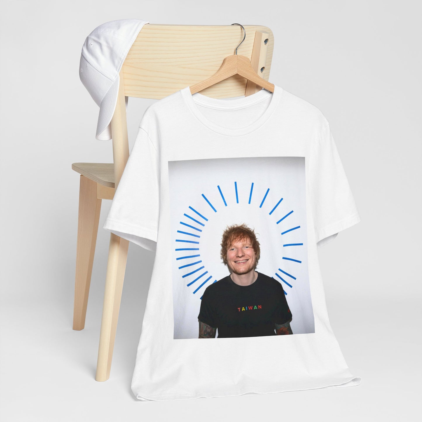 A black graphic t-shirt featuring a classic photo portrait of Ed Sheeran in a folk-pop style.