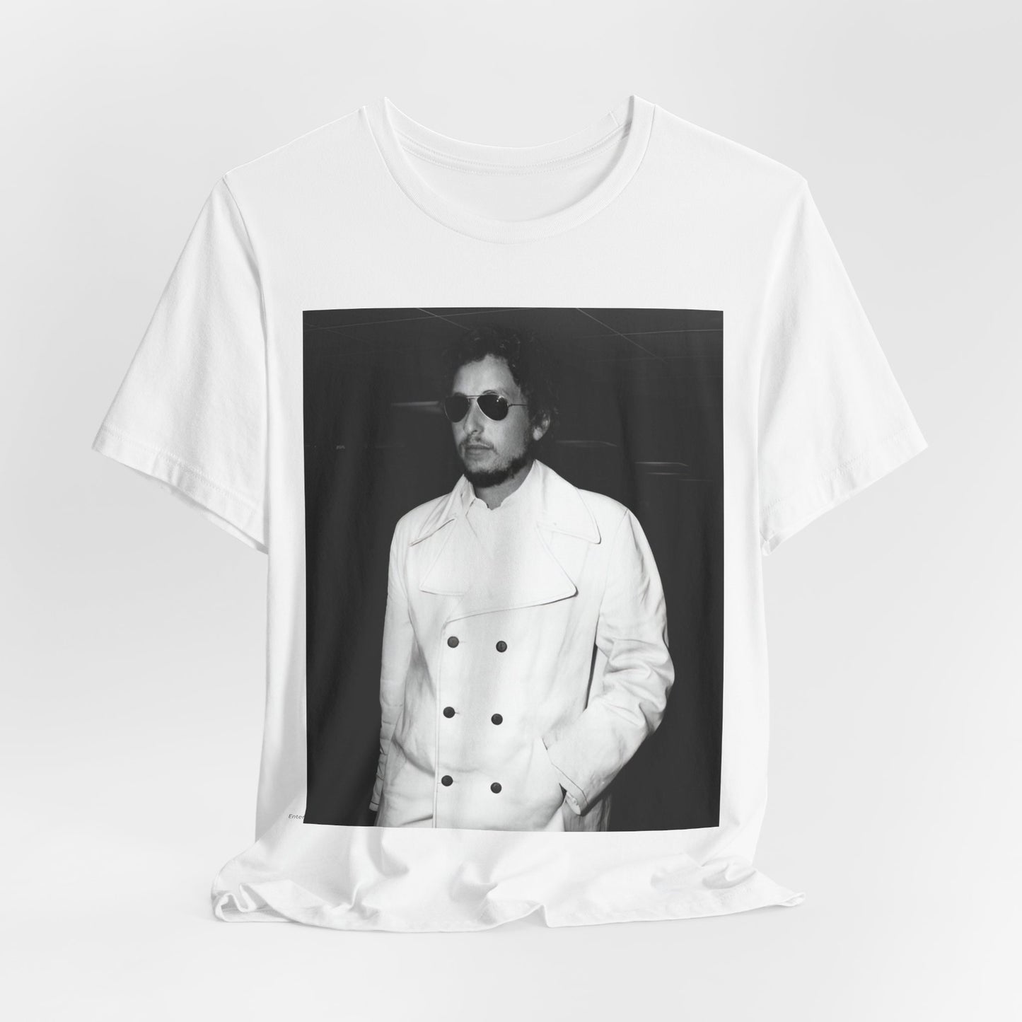 A black graphic t-shirt featuring a vintage black and white photo of Bob Dylan in a contemplative or iconic pose.