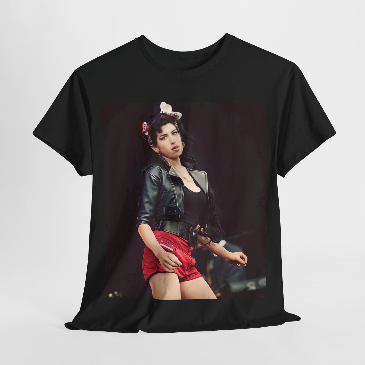 A black graphic t-shirt featuring a photo or illustration of Amy Winehouse on stage, with leather elements and a prominent red background or lighting.