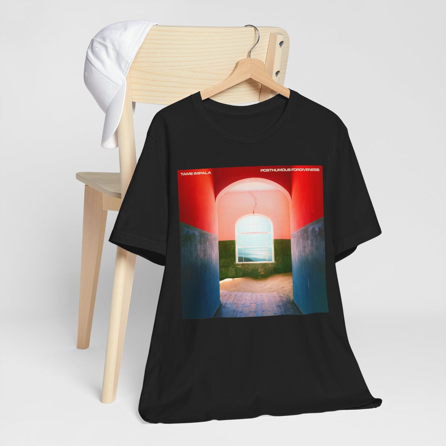 A black graphic t-shirt featuring a graphic related to Tame Impala's song 'Posthumous Forgiveness'.