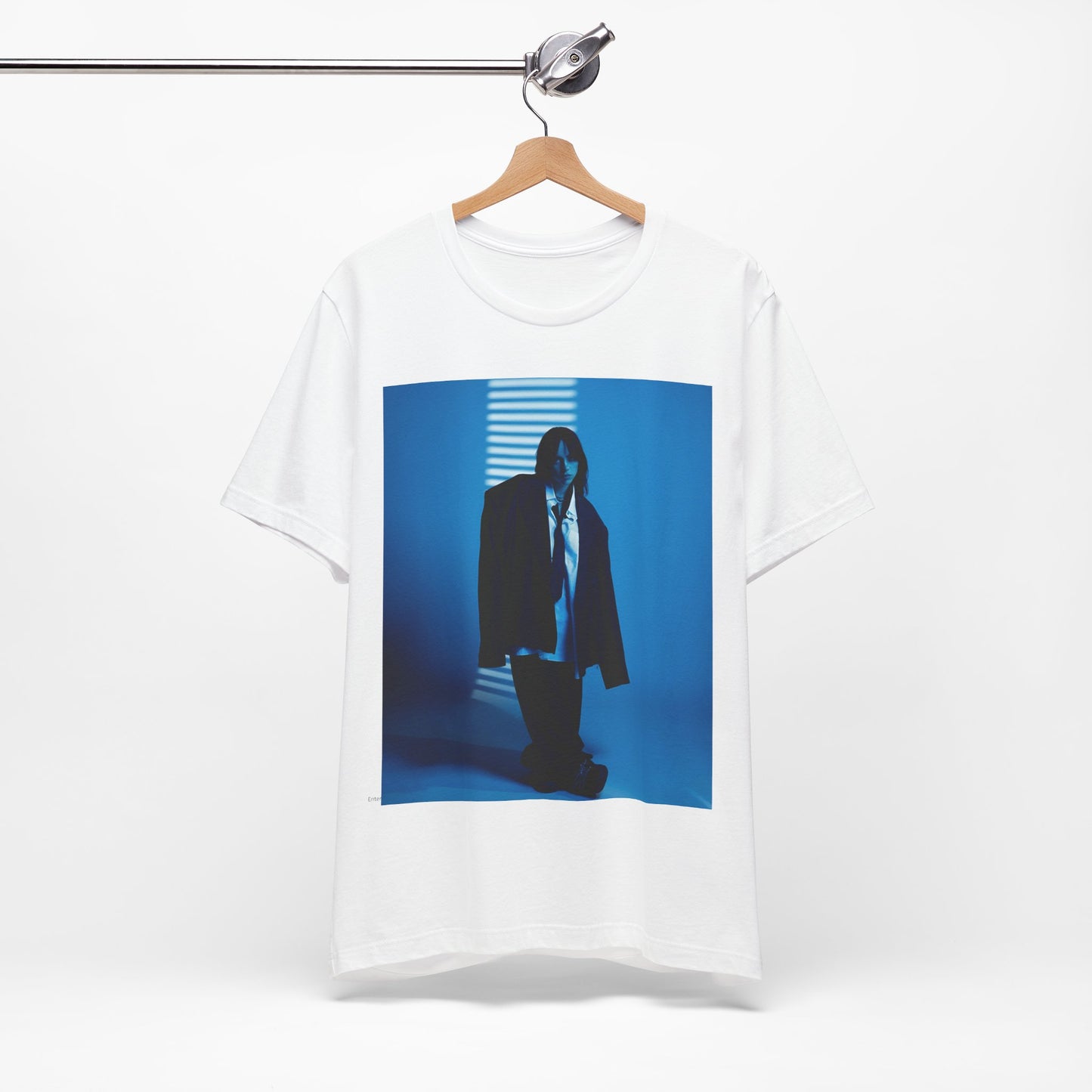 A high-fashion, editorial-style photo of Billie Eilish, embodying a 'breaking the rules' attitude, printed on a graphic t-shirt.