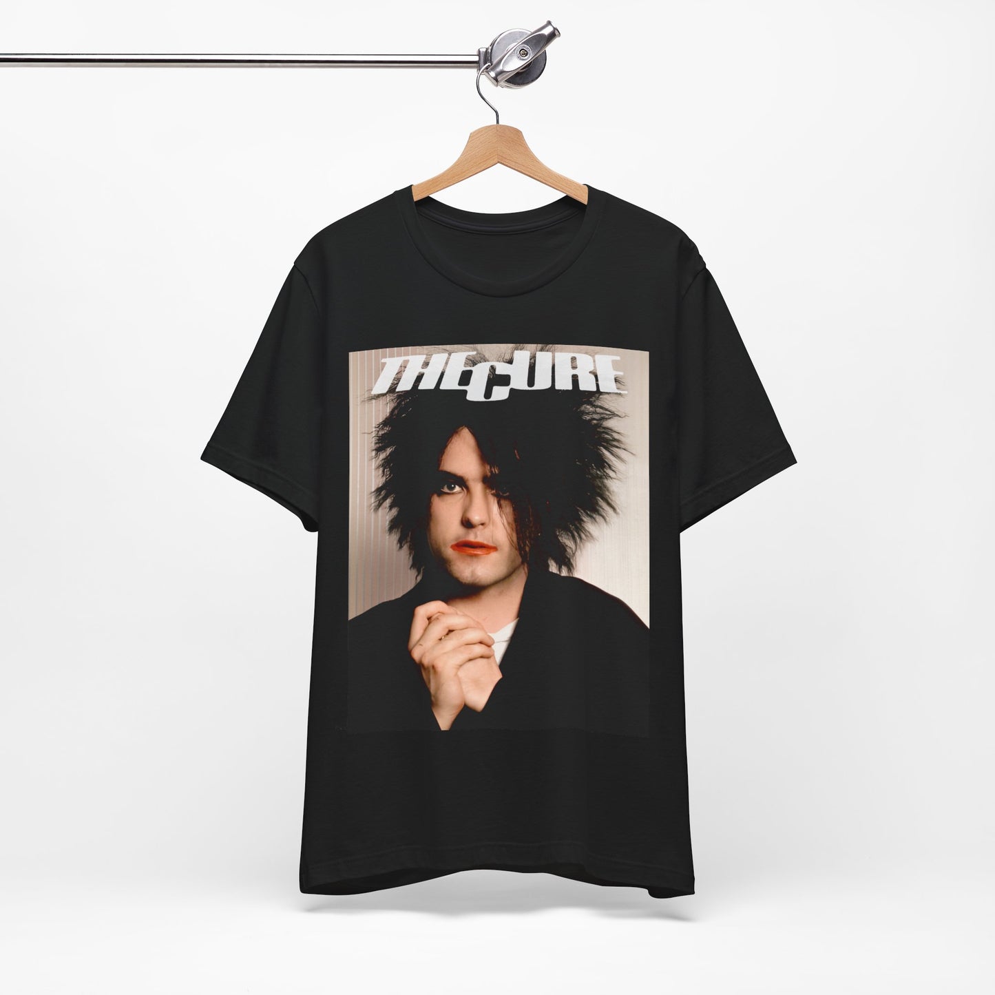 A black graphic t-shirt featuring a 90s portrait photo of Robert Smith from The Cure.