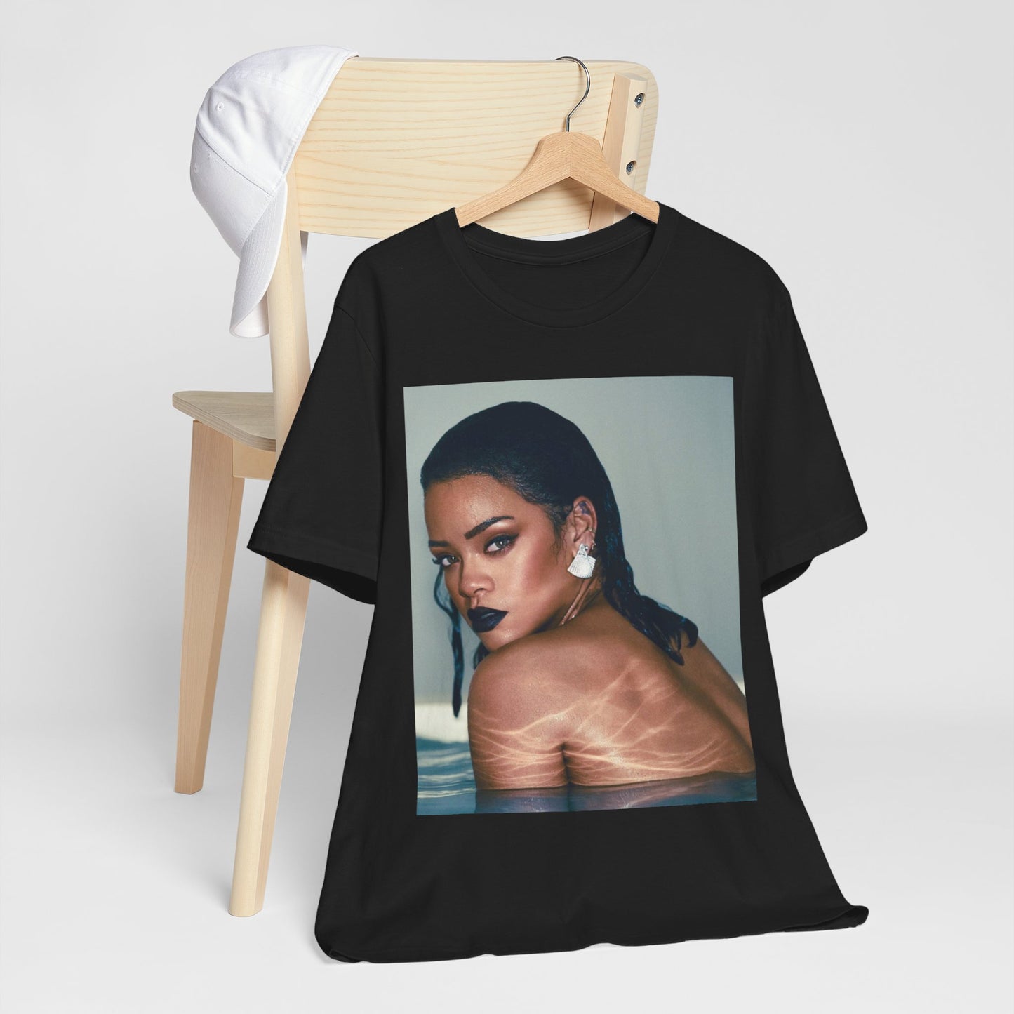 A black graphic t-shirt featuring a vintage pop icon graphic of Rihanna.