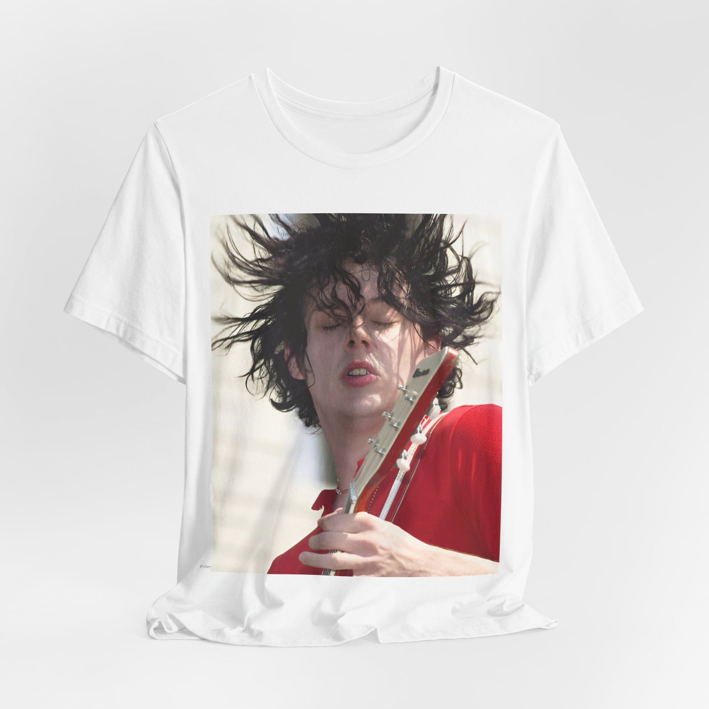 A black graphic t-shirt featuring a retro graphic of Jack White from The White Stripes playing guitar.