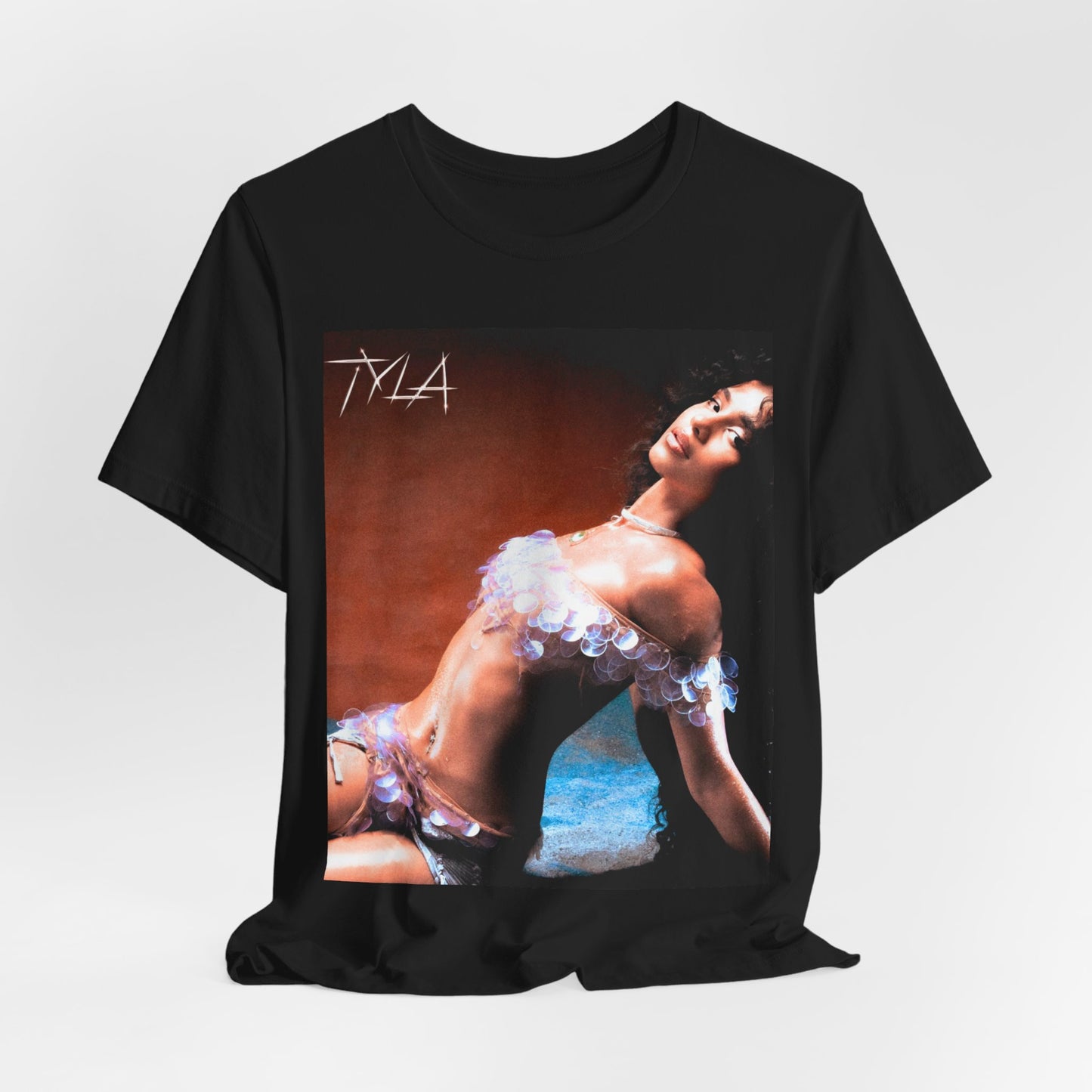 A black graphic t-shirt featuring a cultural fusion vibes graphic of Tyla.