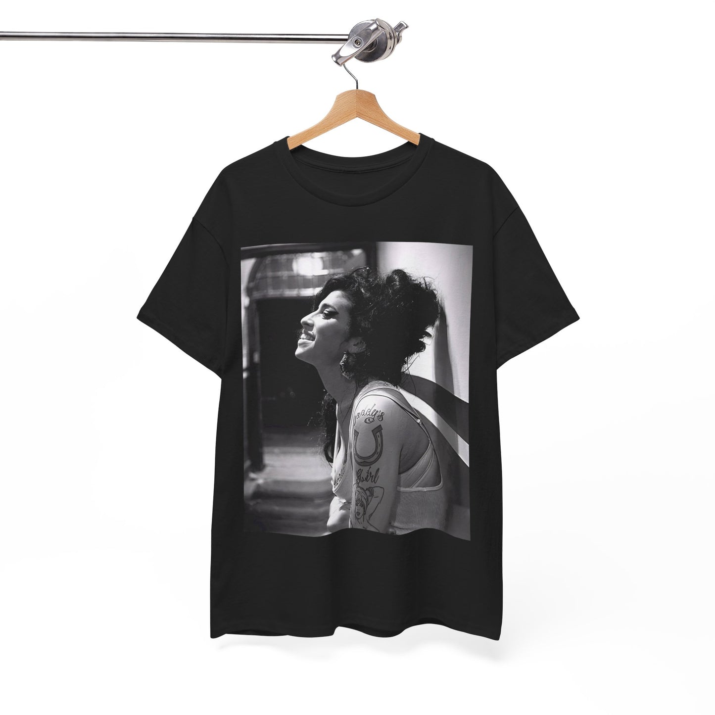 A black graphic t-shirt featuring a candid backstage photo of Amy Winehouse from her 'Back to Black' era, showing her in a relaxed setting.