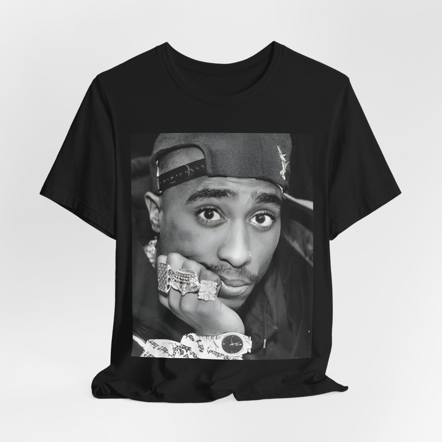 A black graphic t-shirt featuring a bold graphic of Tupac as a rap superstar.