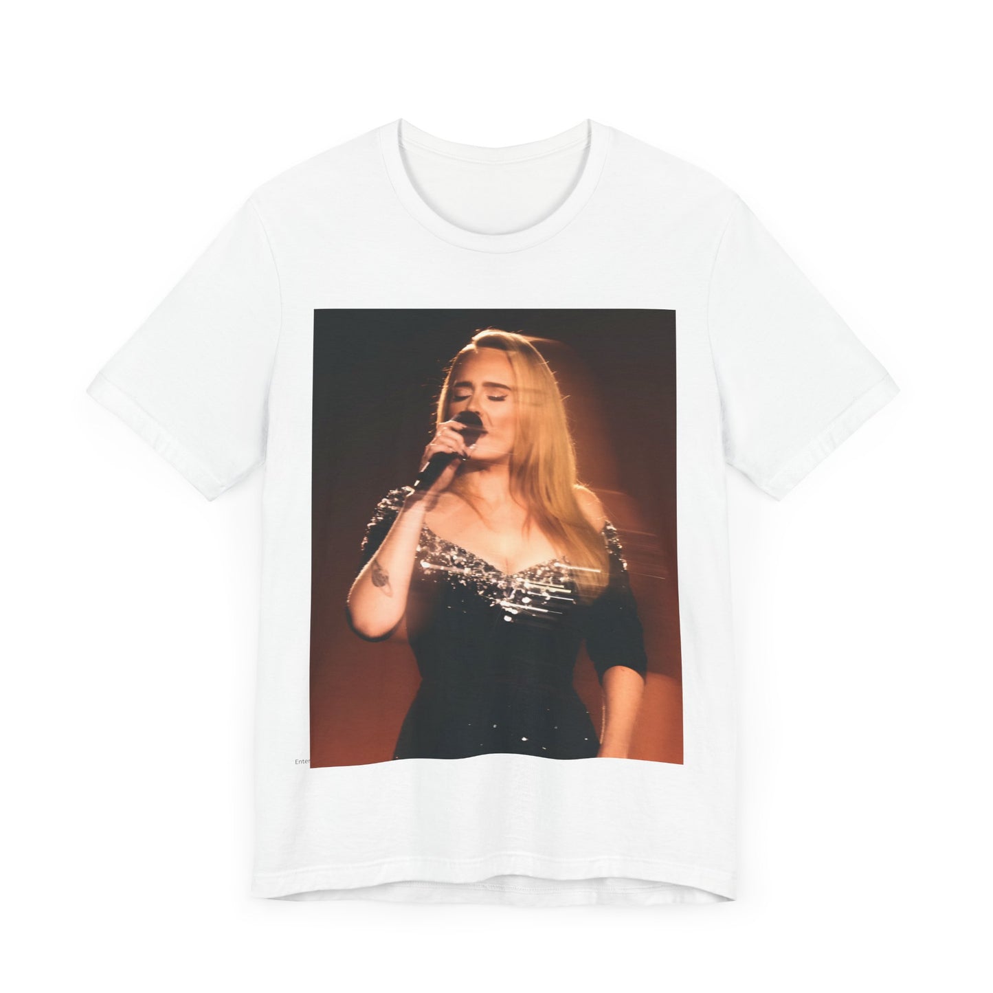 A black graphic t-shirt featuring a stylized image or photo of Adele related to her Las Vegas residency, possibly with elements of stage lighting or show branding.
