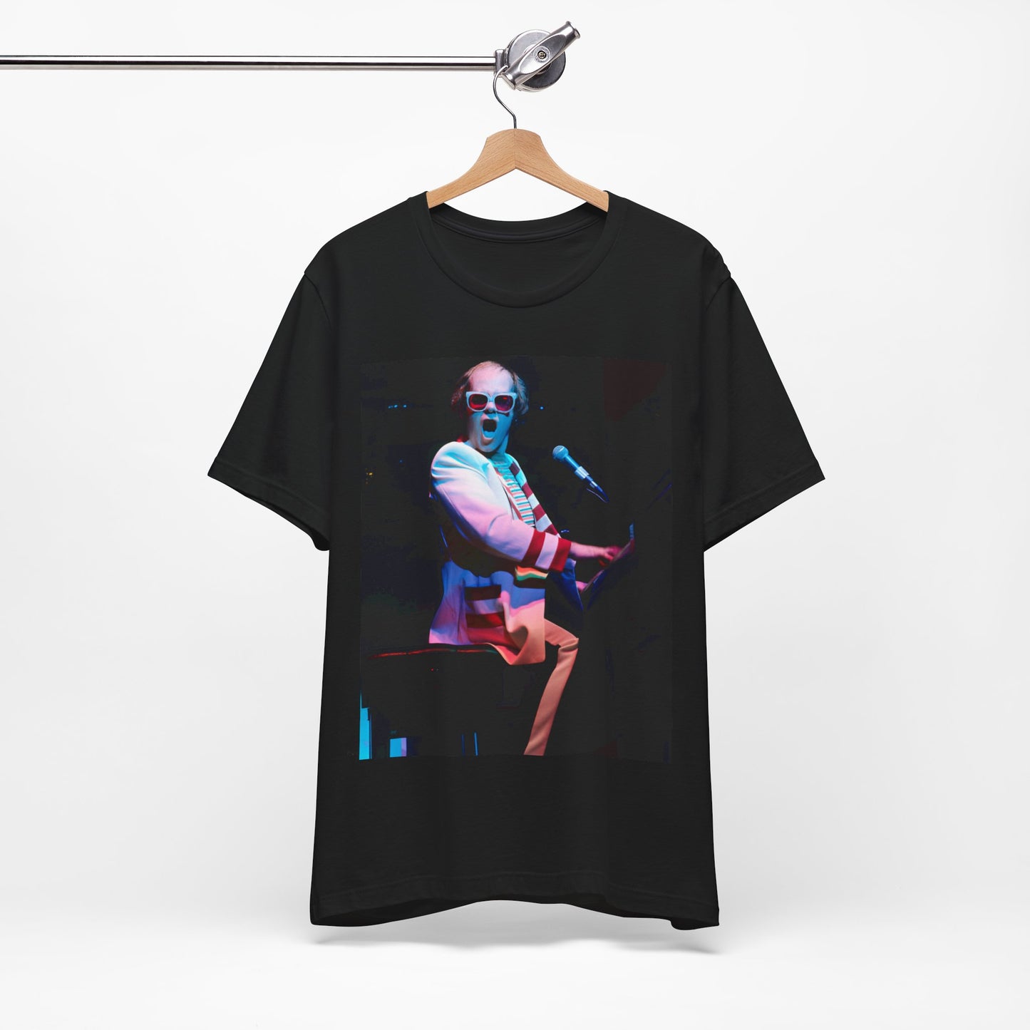 A black graphic t-shirt featuring a photo of Elton John performing live on stage at his piano.