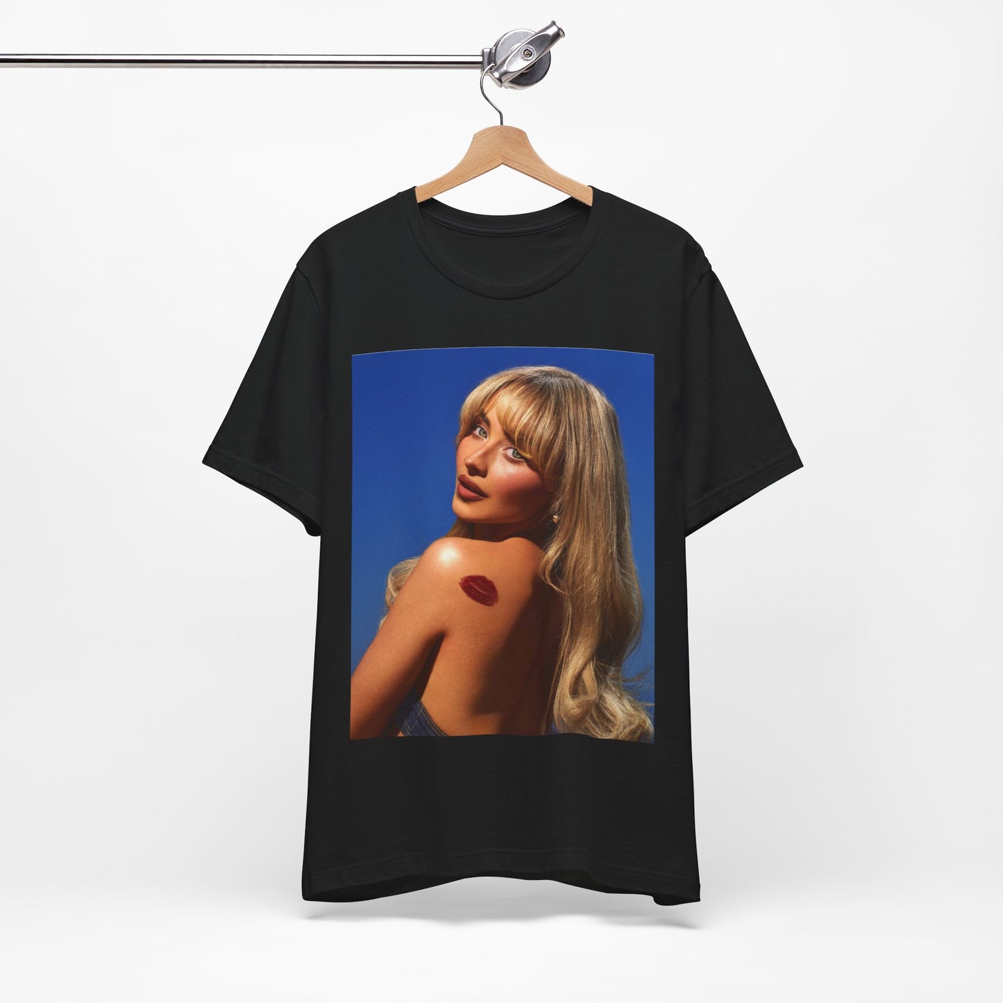 A black graphic t-shirt featuring a stylized graphic of Sabrina Carpenter, designed with a modern pop aesthetic.