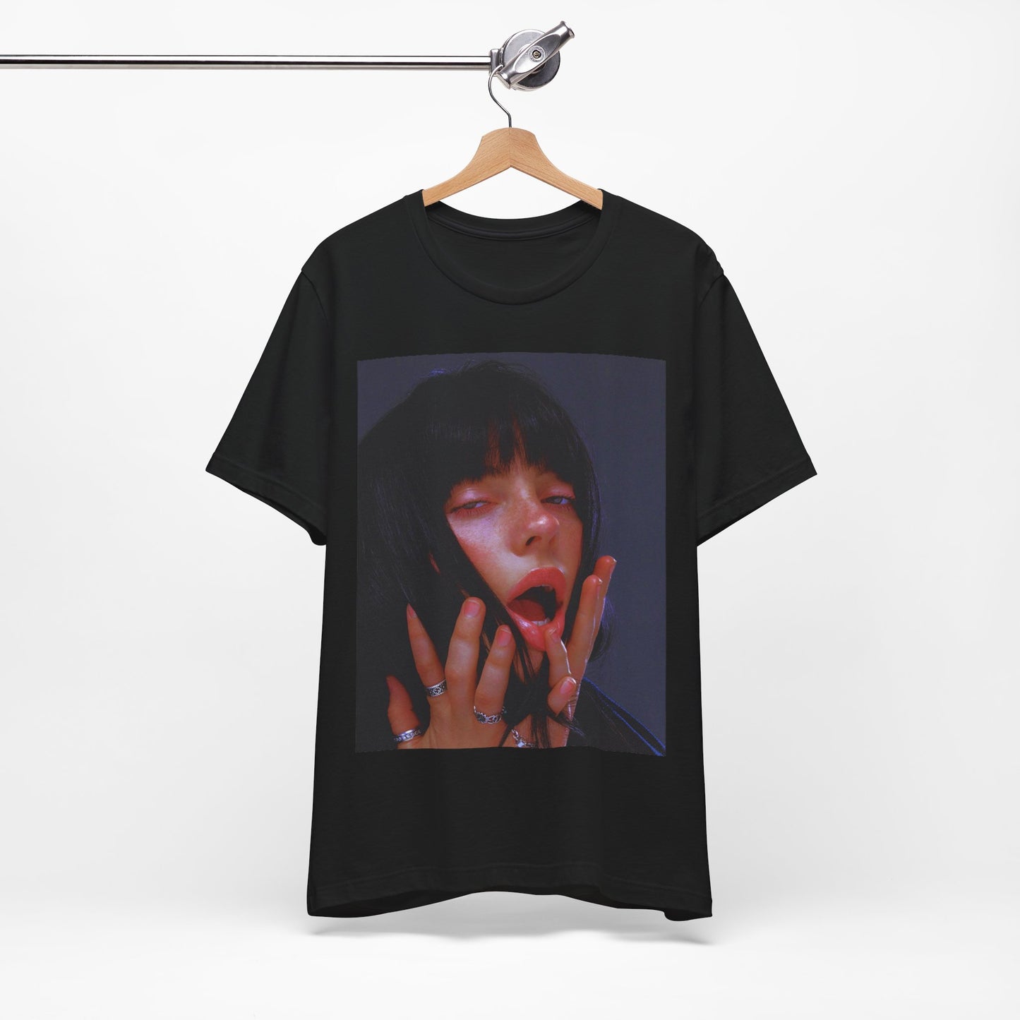 An intense, artistic photo of Billie Eilish with a bloody nose, conveying a sense of raw power, printed on a graphic t-shirt.