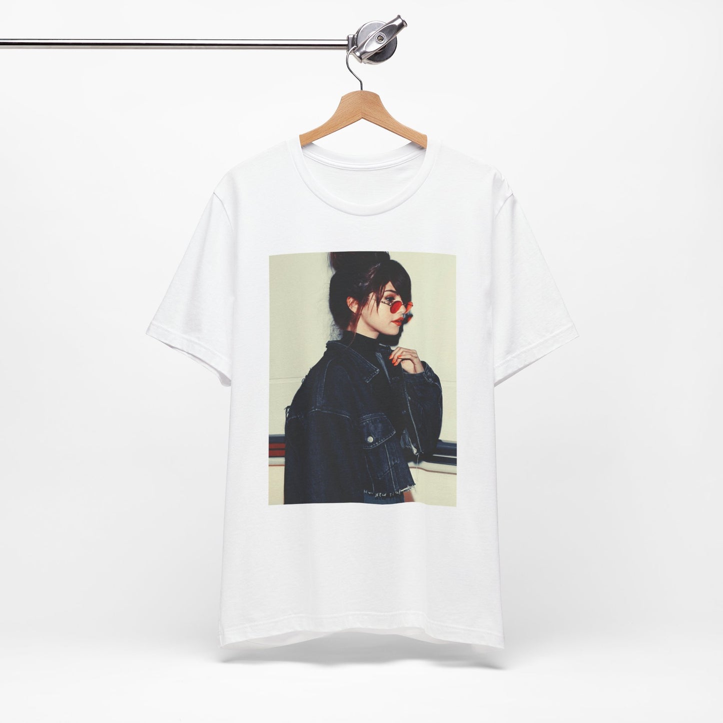 A black graphic t-shirt featuring a bold graphic of Selena Gomez as a pop superstar.