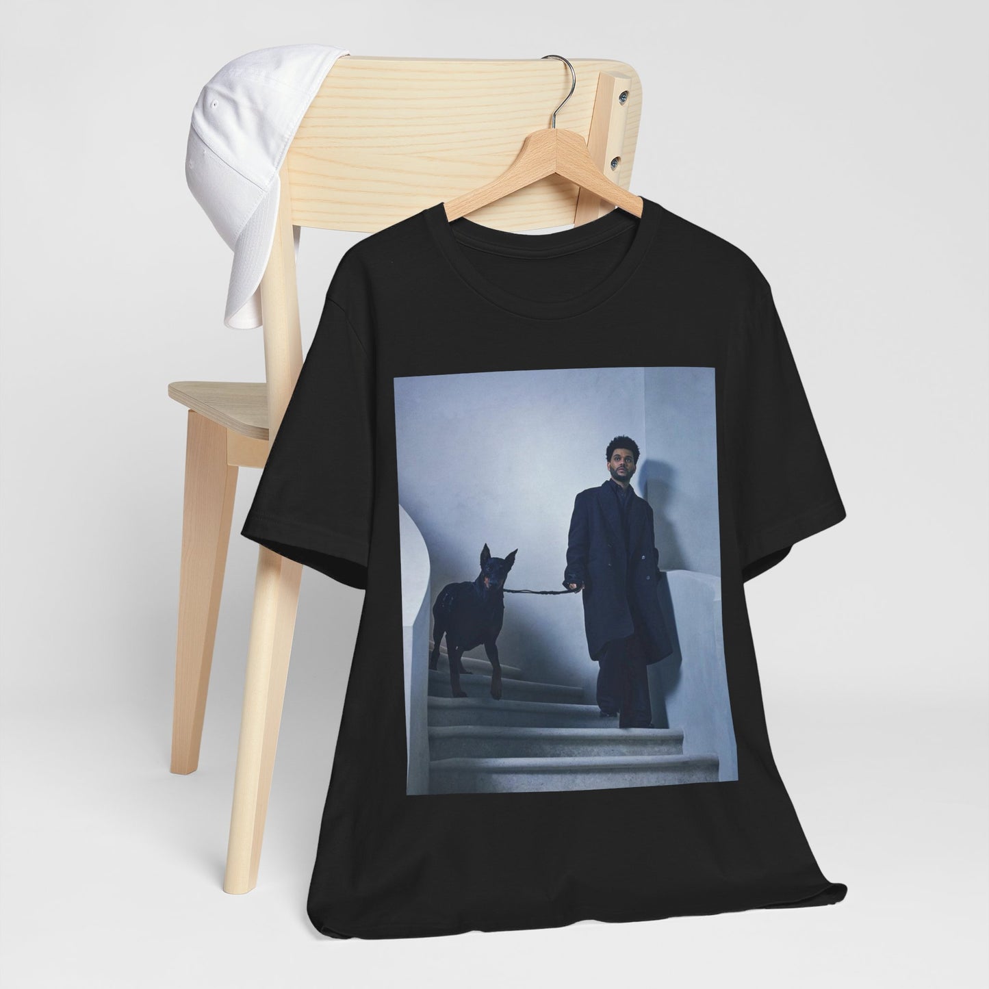 A black graphic t-shirt featuring a photo of The Weeknd with a doberman.