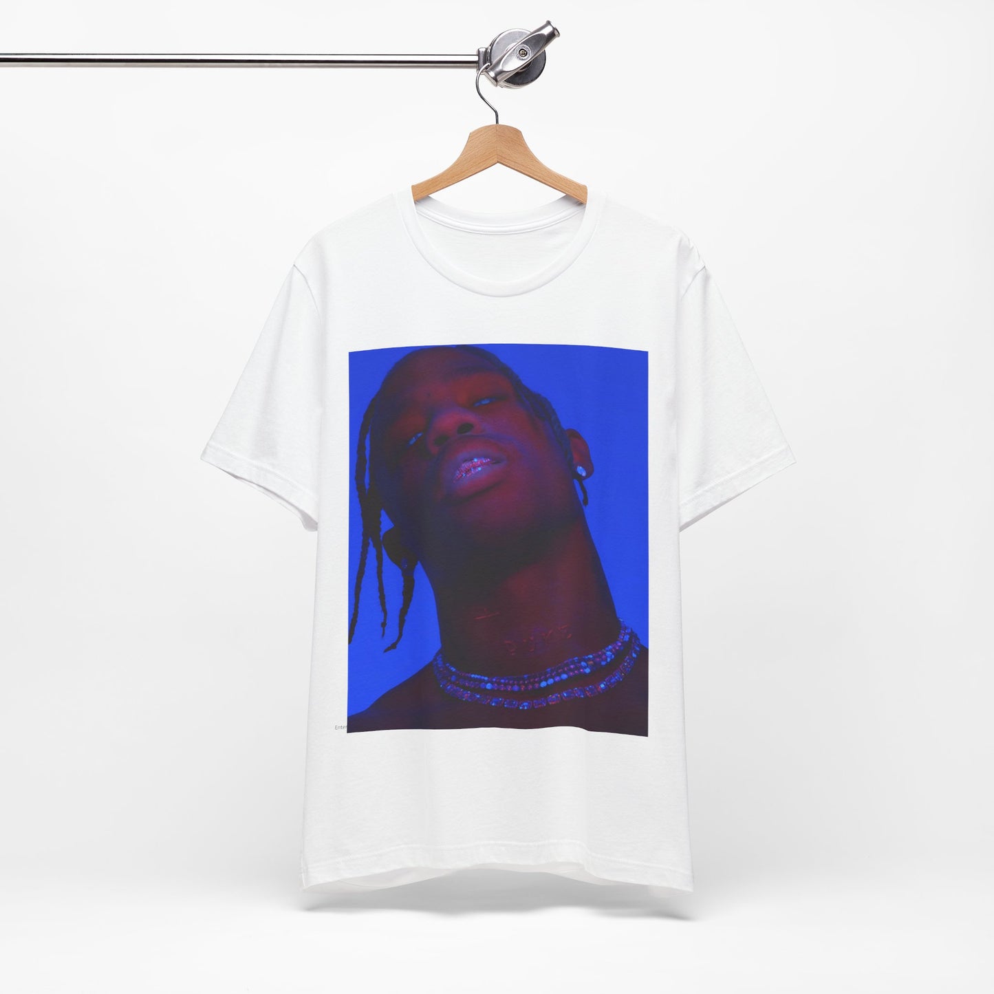 A black graphic t-shirt featuring a bold graphic of Travis Scott as a rap superstar.