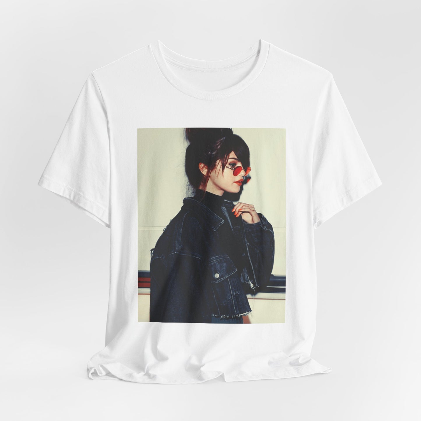 A black graphic t-shirt featuring a bold graphic of Selena Gomez as a pop superstar.