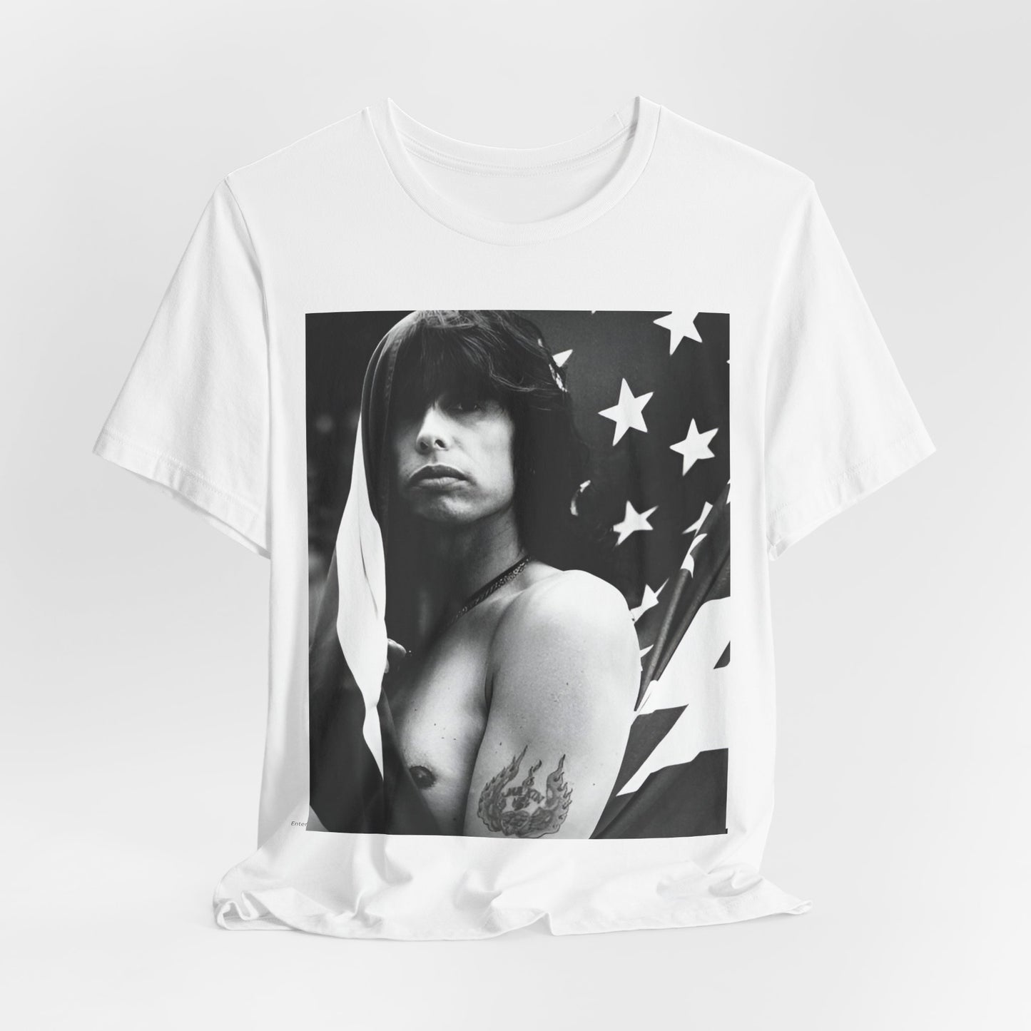 A black graphic t-shirt featuring a retro 70s-style illustration or photo of Aerosmith, integrated with elements of the American flag.