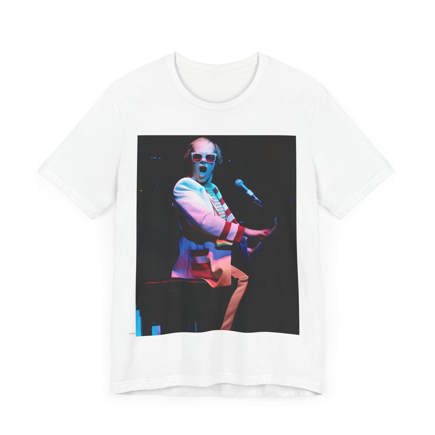 A black graphic t-shirt featuring a photo of Elton John performing live on stage at his piano.