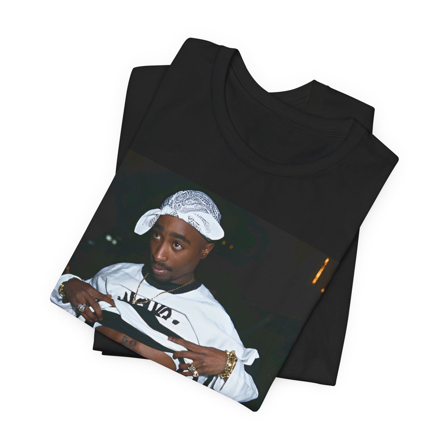 A black graphic t-shirt featuring a graphic of Tupac Shakur (2Pac).
